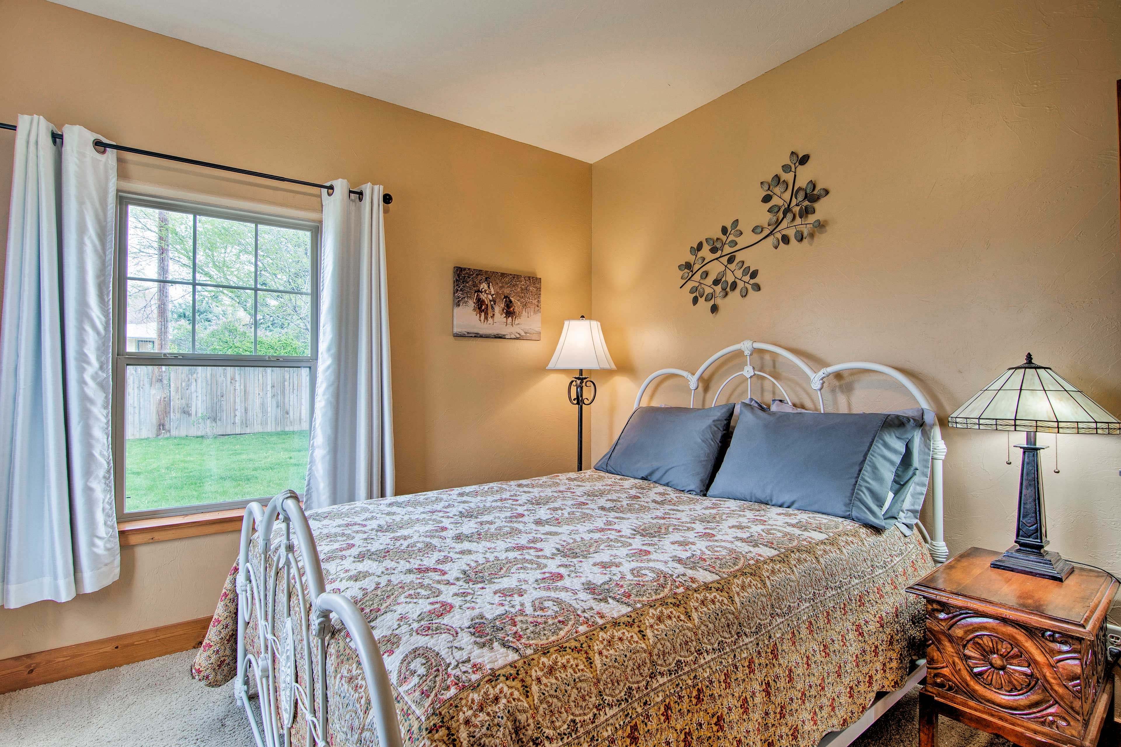 The second bedroom is outfitted with a queen bed.