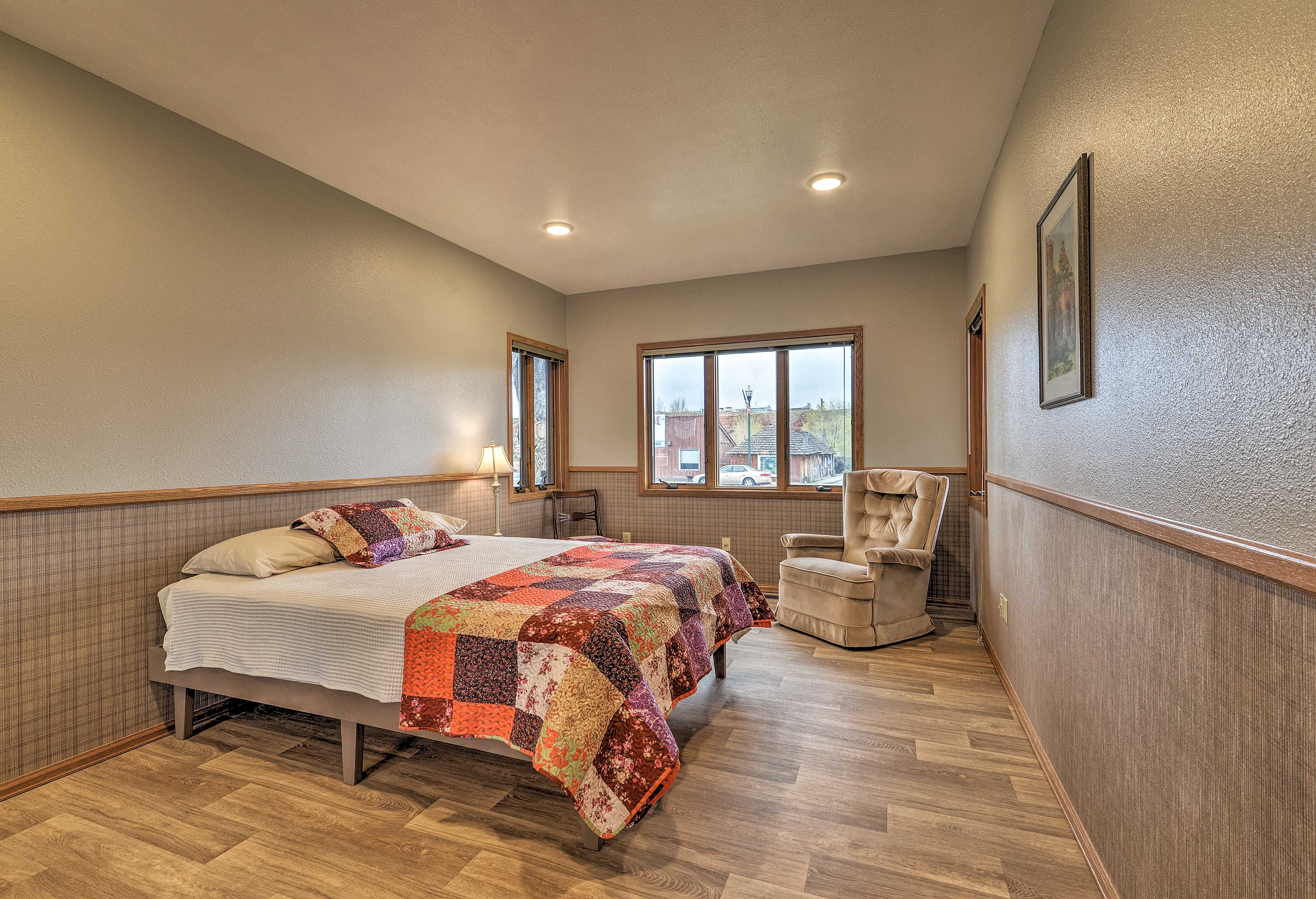 The second bedroom includes a queen bed and cozy armchair.