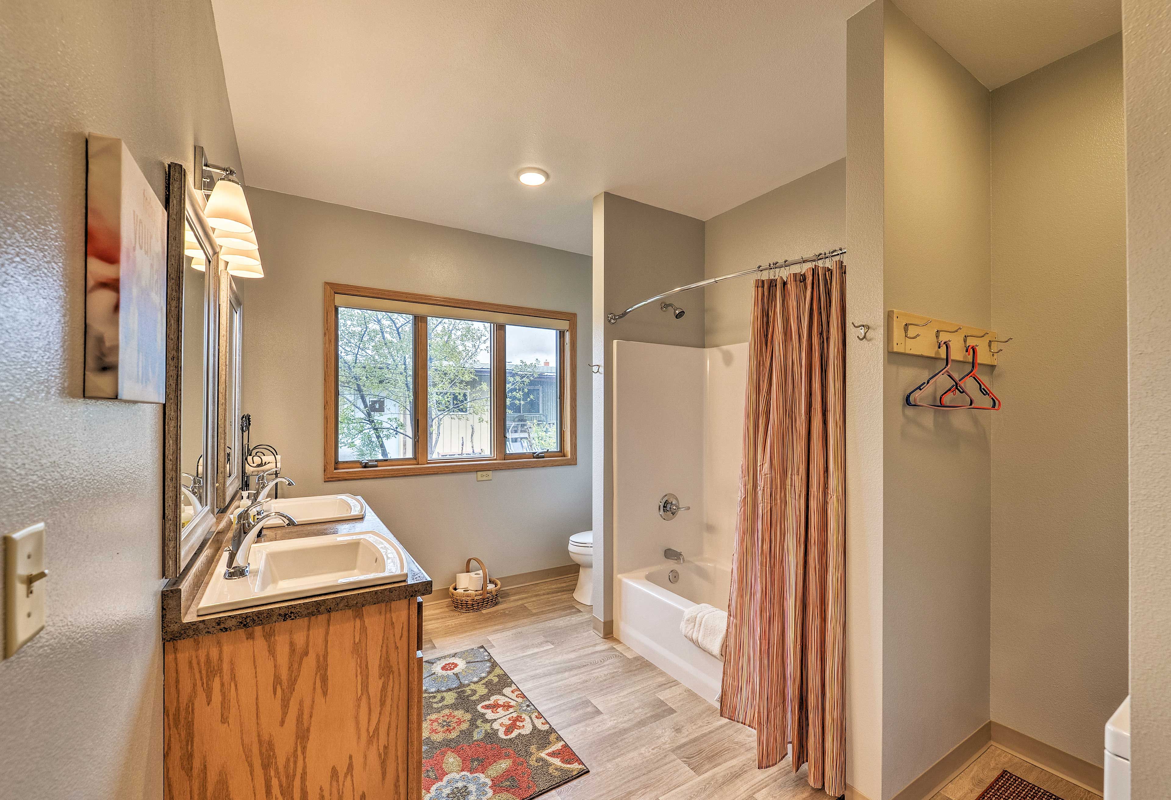 The unit's bathroom includes a shower/tub combo and dual-sink vanity.