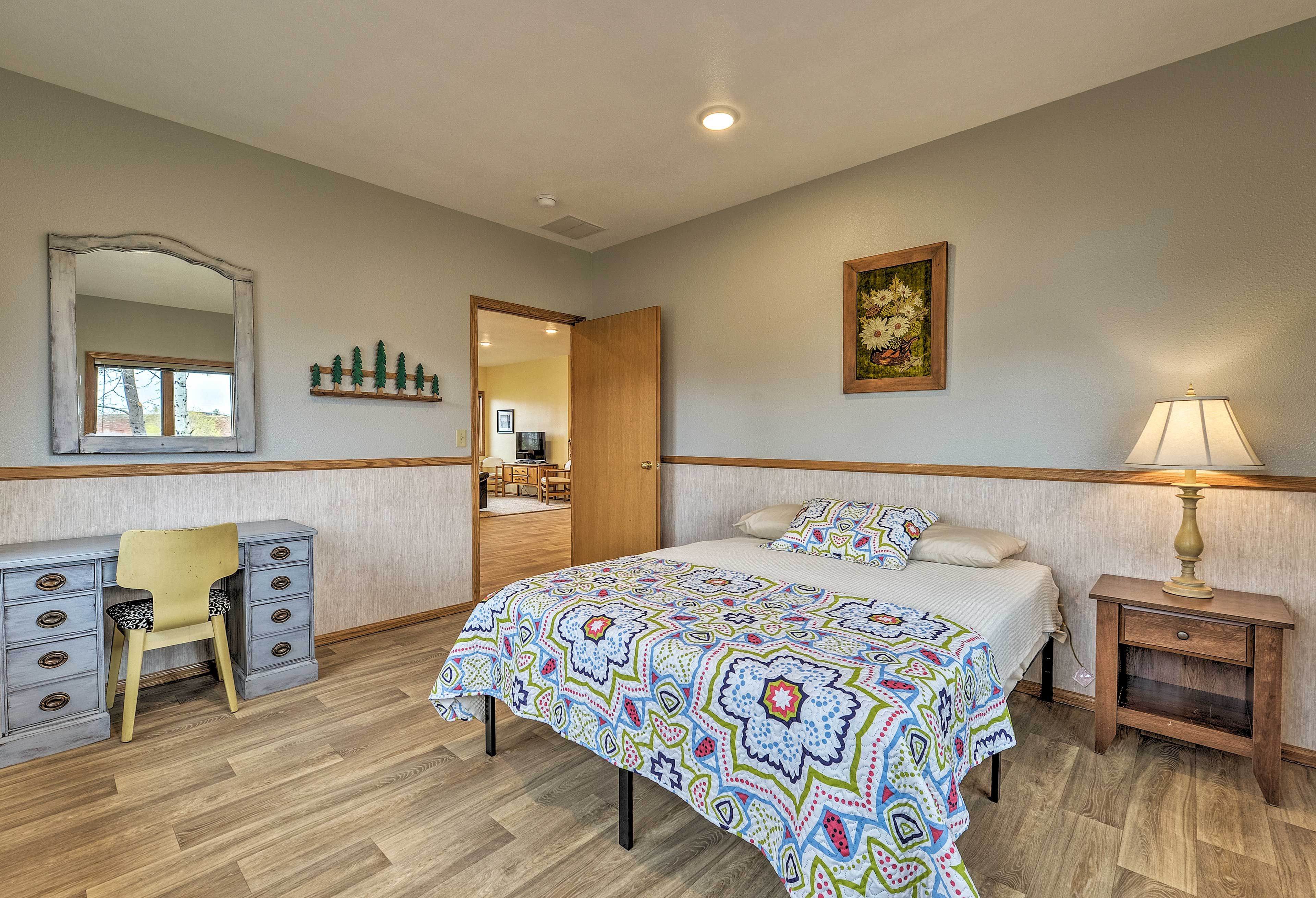 The first bedroom boasts a queen bed and laptop-friendly desk.