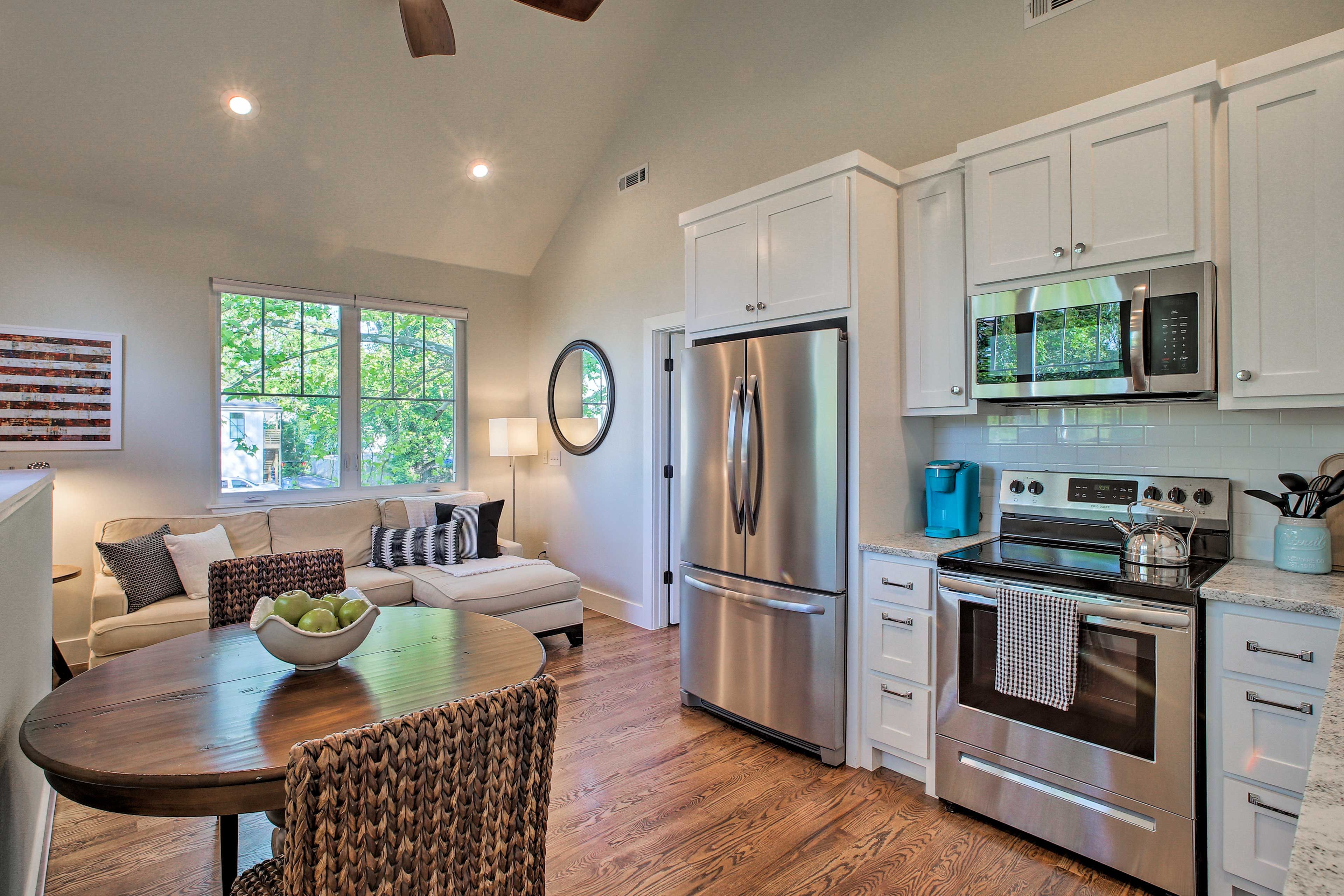 The open living area boasts vaulted ceilings and homey decor.