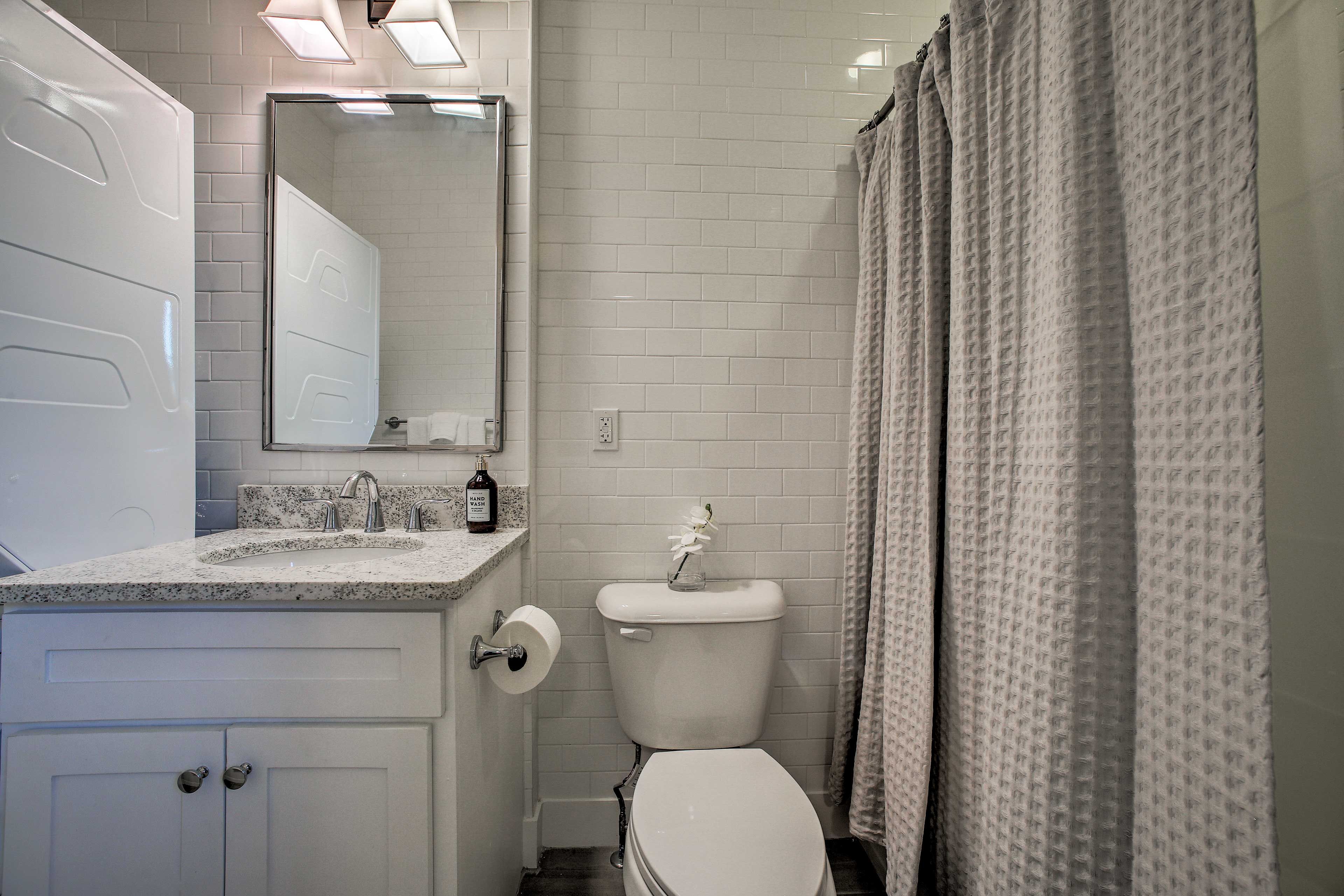 Subway tiles cover the bathroom from floor to ceiling.