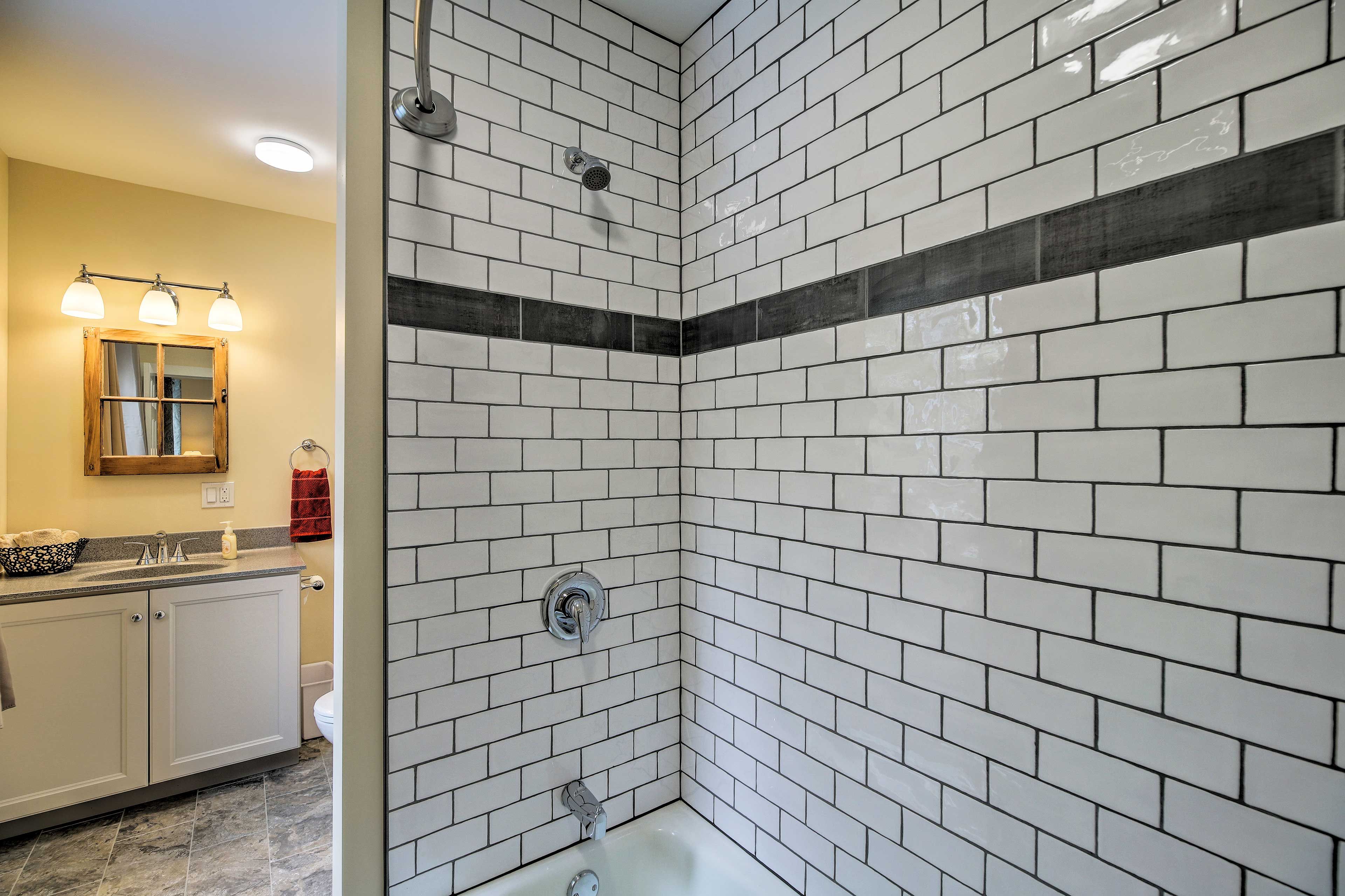 Rinse off the day in the shower of this full bathroom.