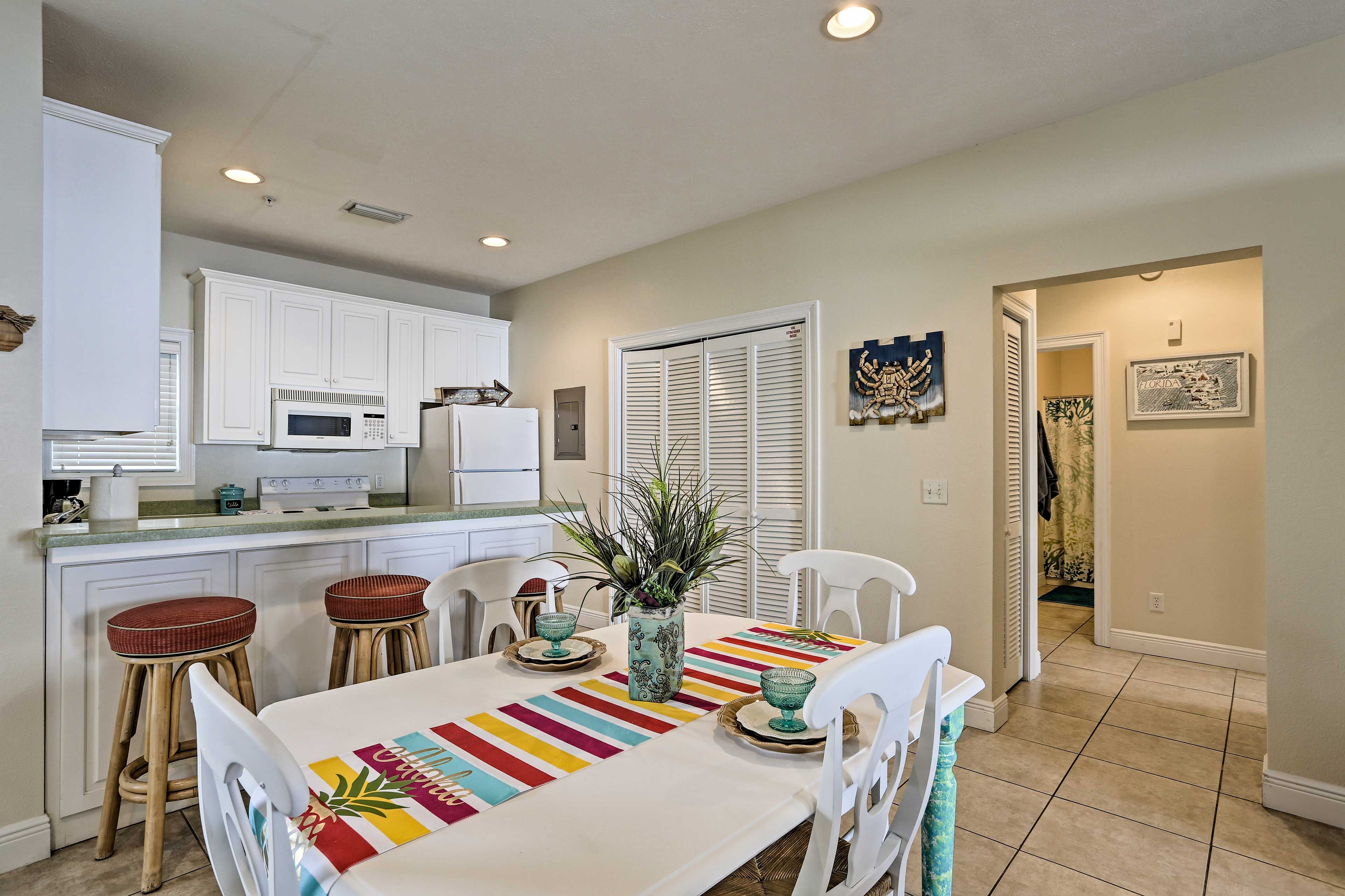 Set the white dining table for a formal meal.