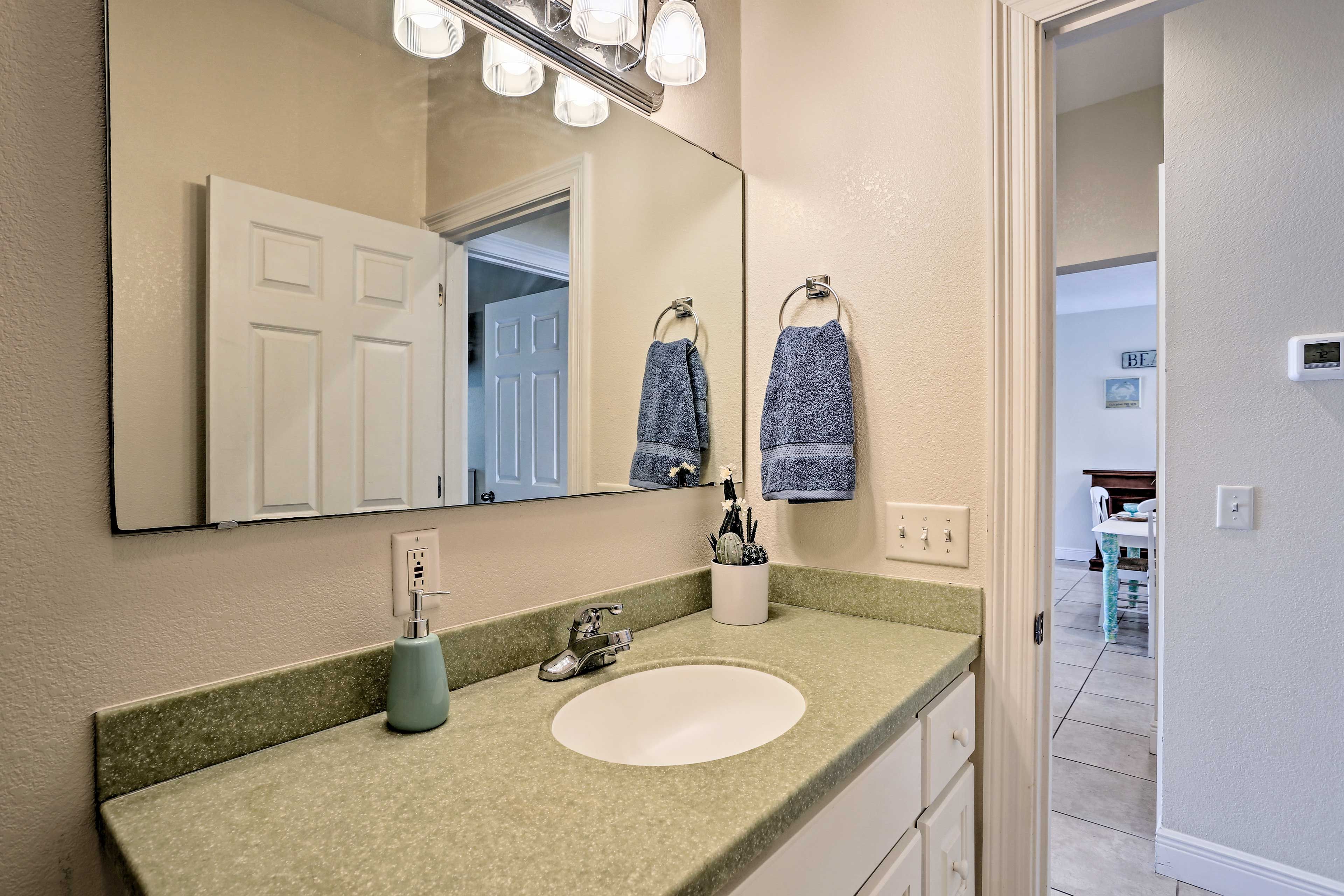 The first bathroom is around the corner from the living room.