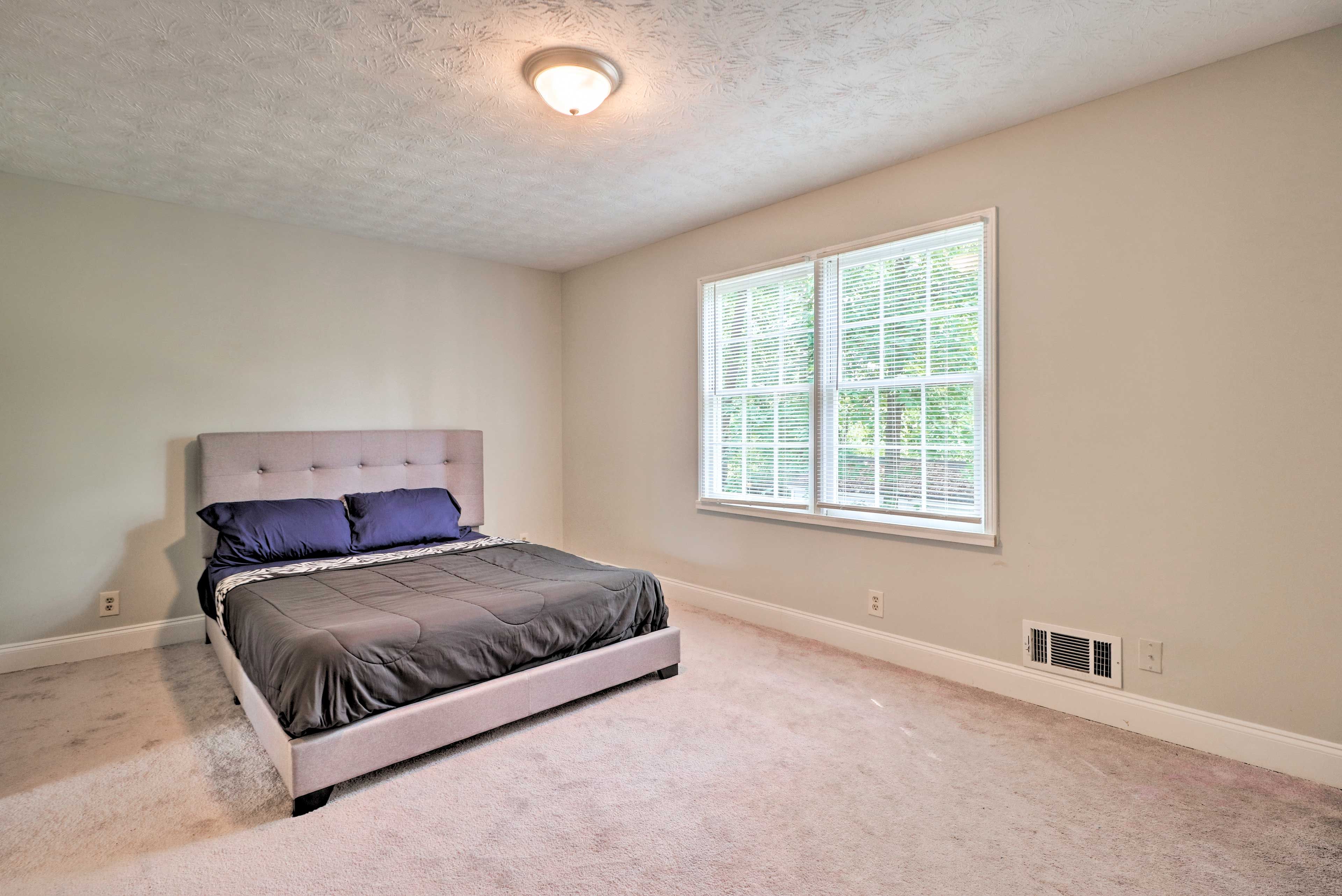 Bright and spacious, this bedroom hosts a queen bed as well.