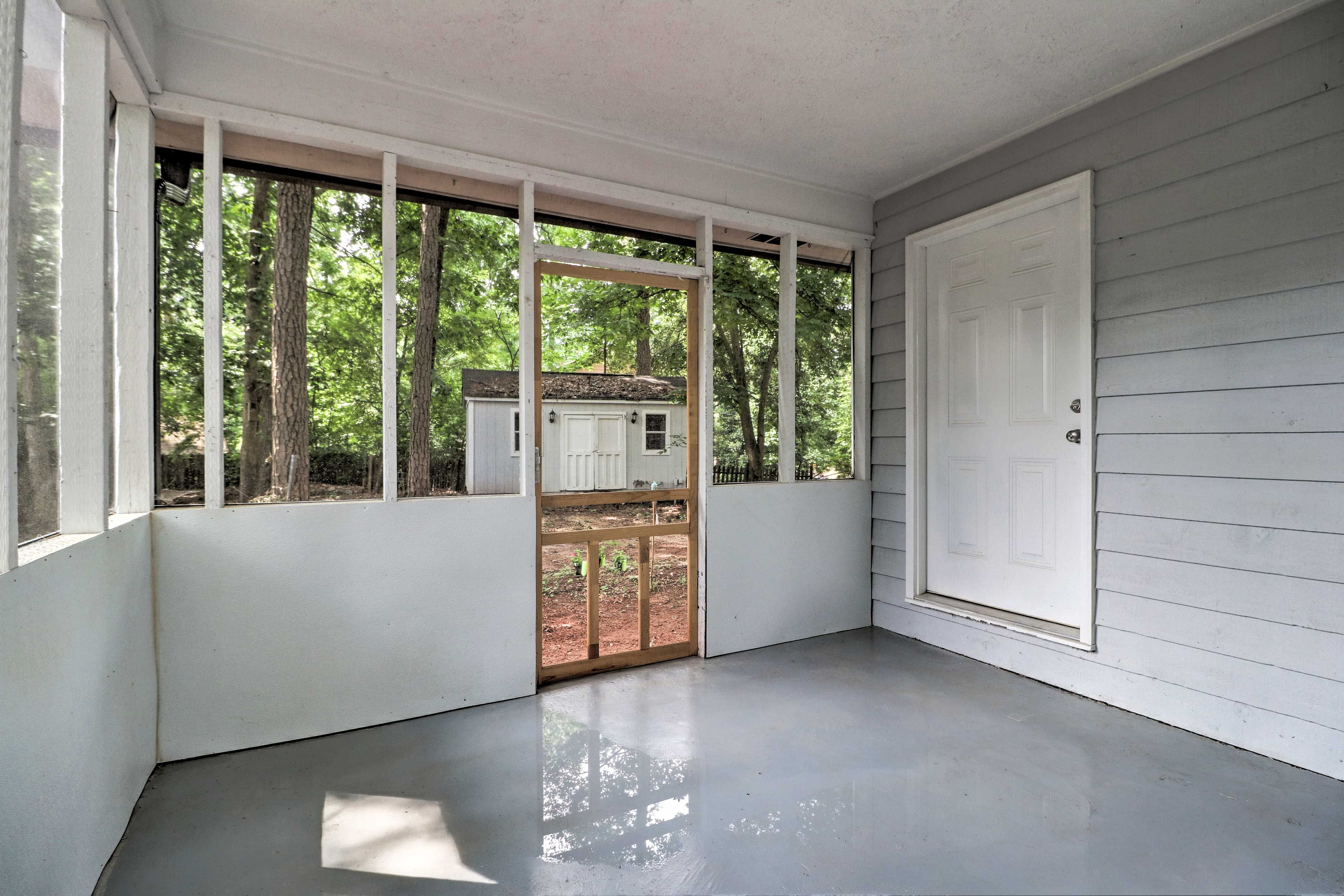 Enjoy the lush forest surroundings from the pest-free screened-in porch.