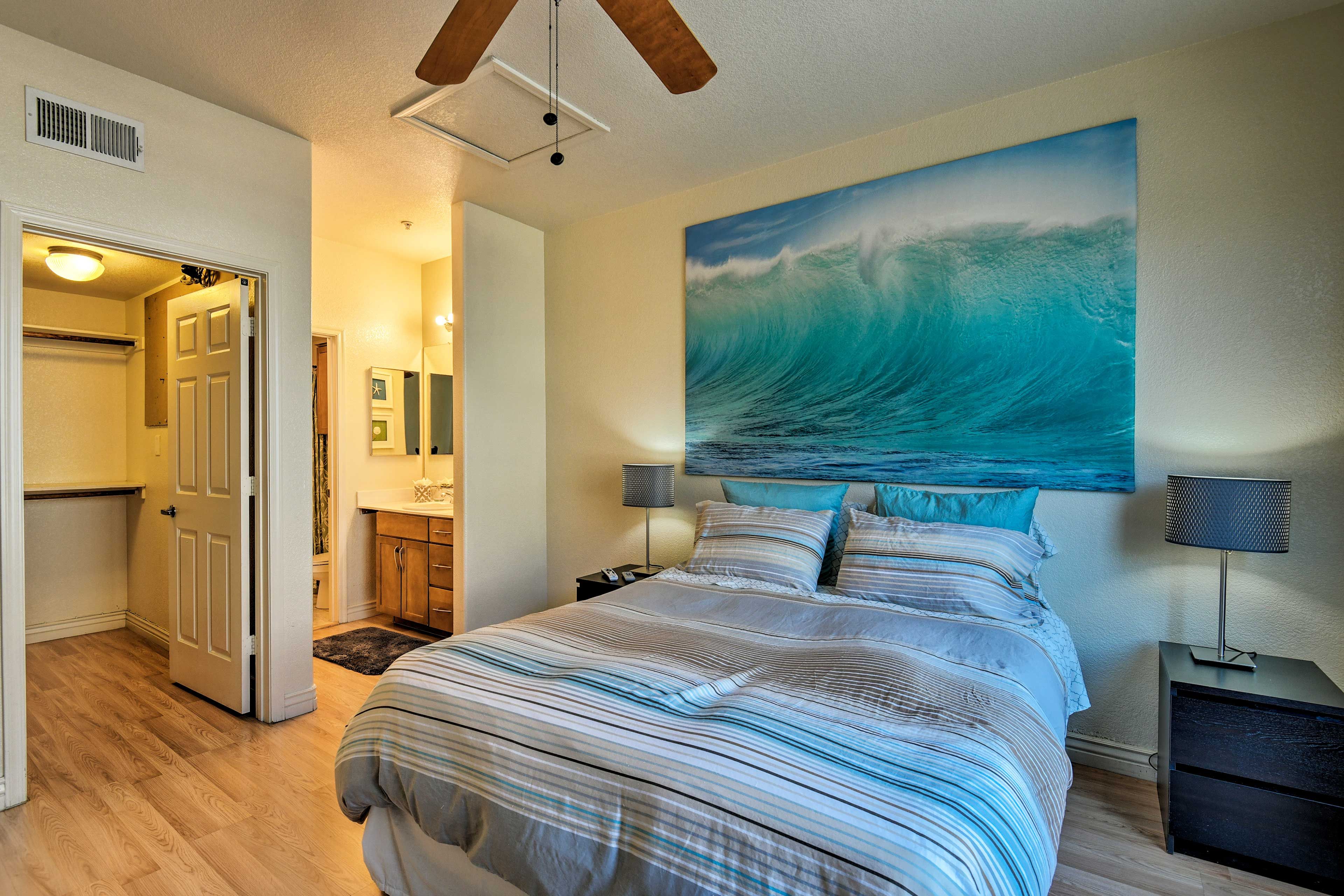 The first bedroom boasts a queen-sized bed and a walk-in closet.