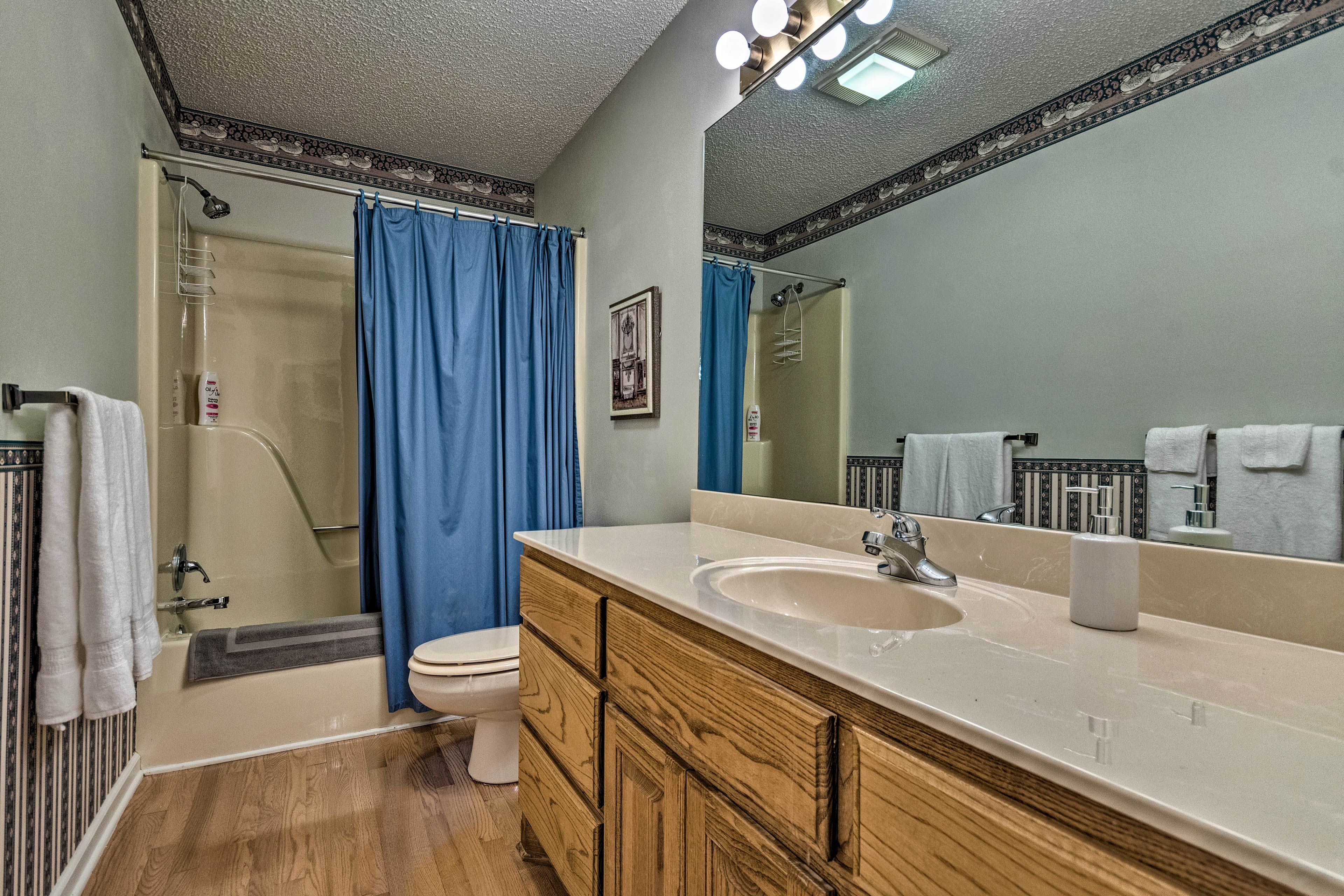The shower/tub combo features grab rails.