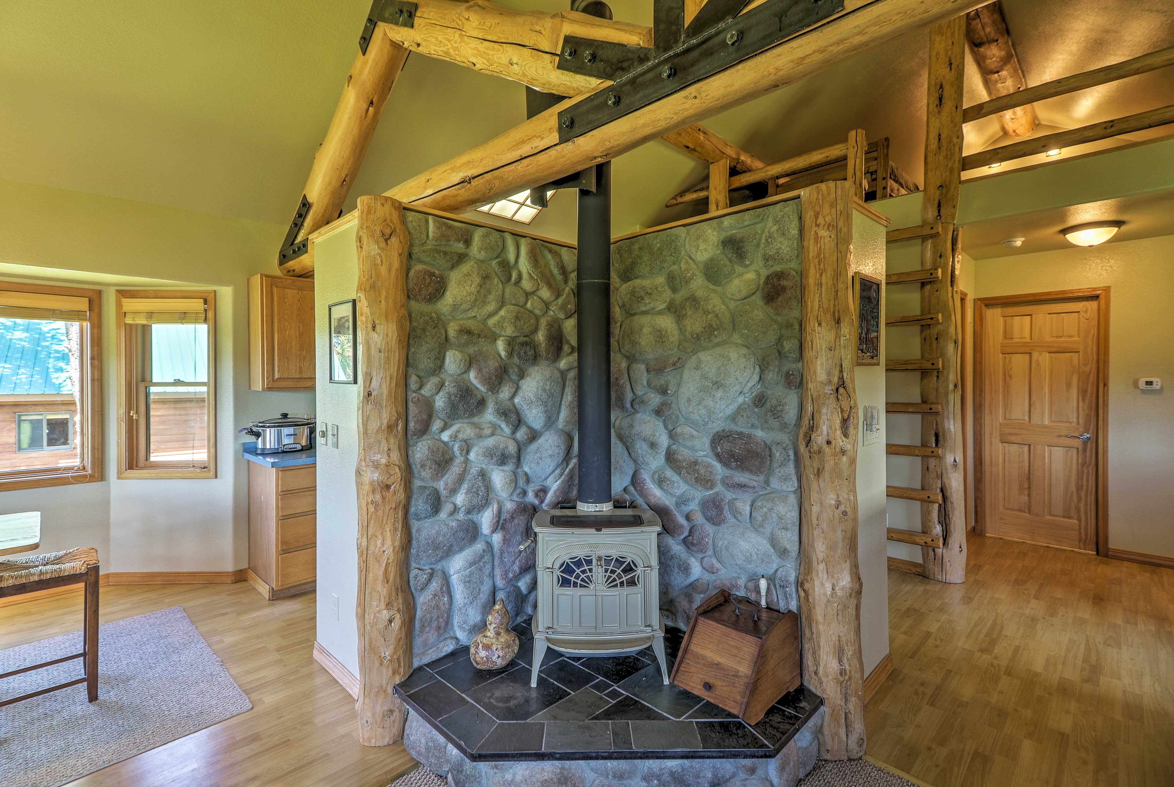 The exposed logs and smoothed river rock add a rustic touch to the room.