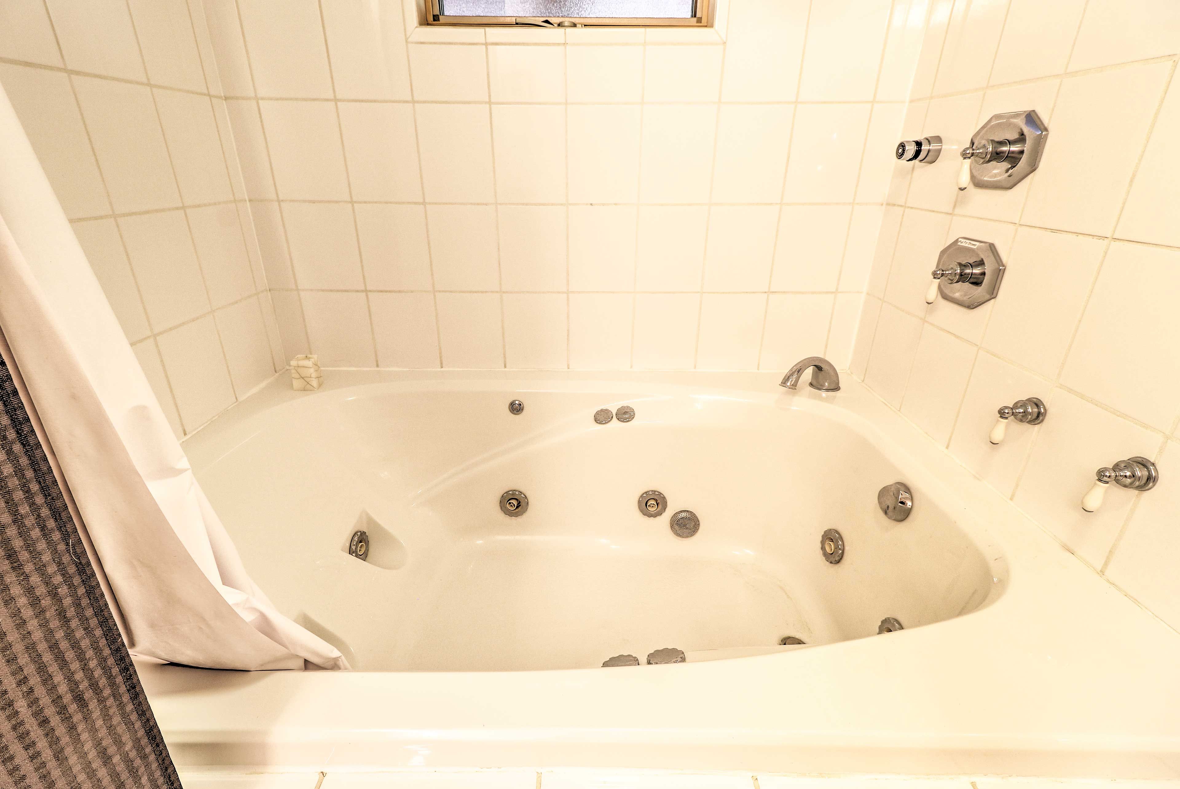 Enjoy this jetted tub coupled with a glass of wine!