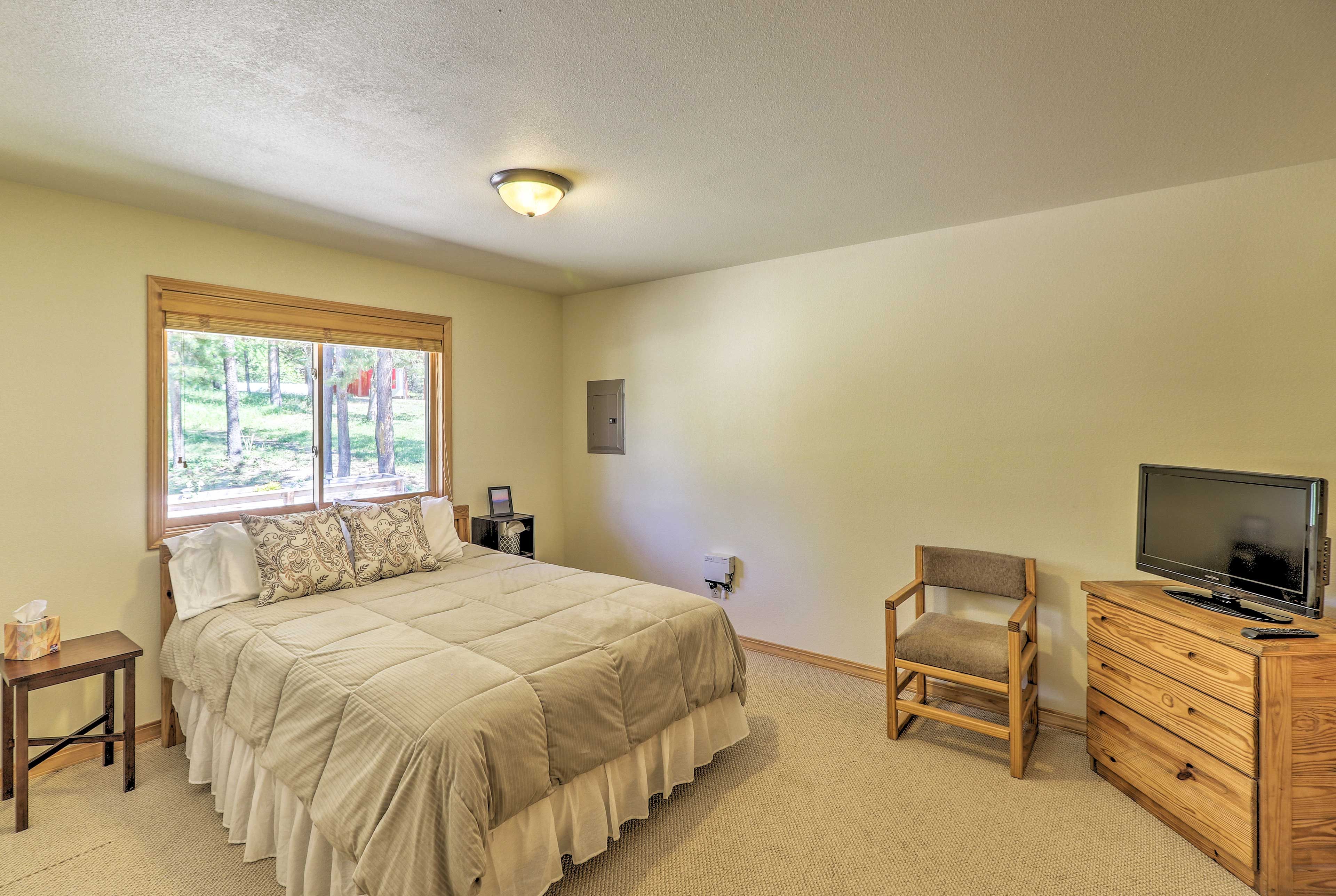 The master bedroom houses queen-sized bed and a flat-screen cable TV.