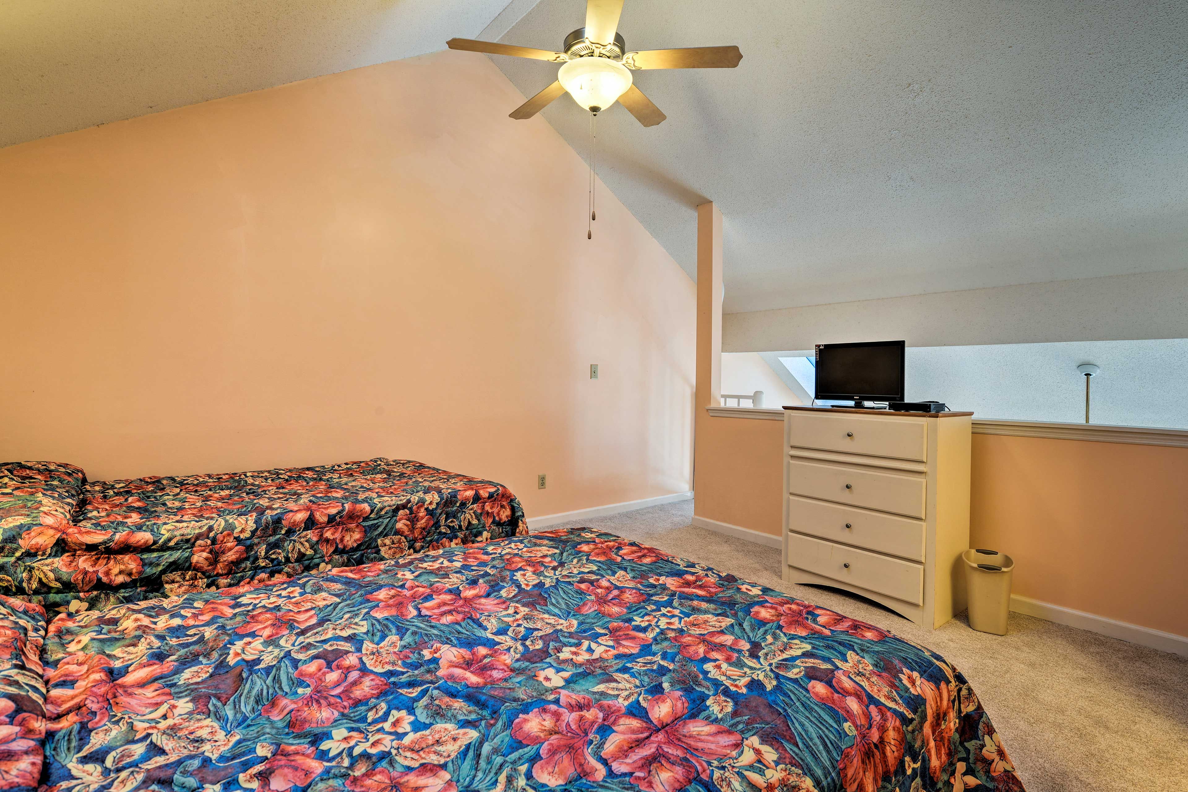 This bedroom features a queen and a full-sized bed.