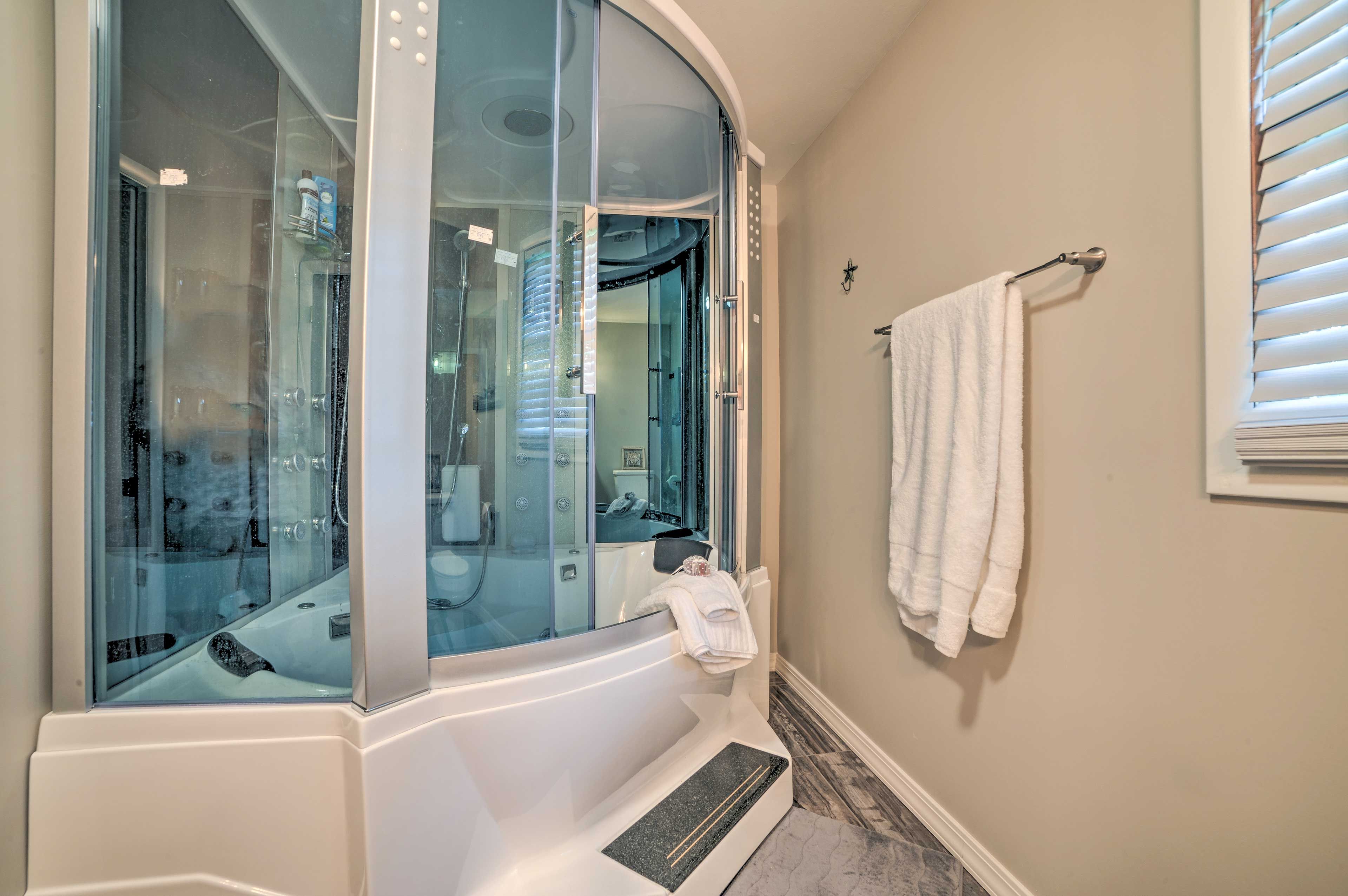 Enjoy a relaxing soak in the large bathtub.