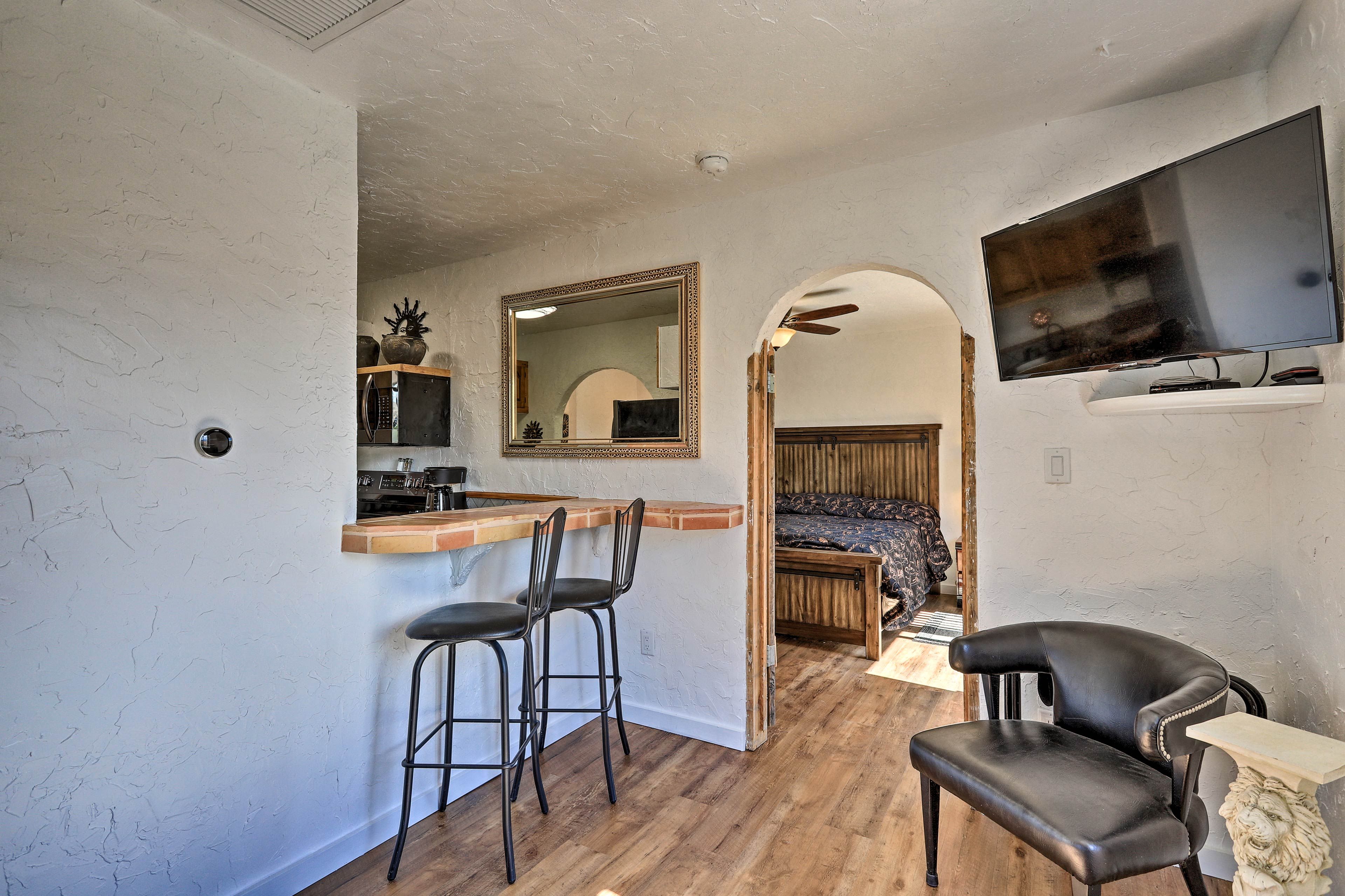 Watch TV while others sip wine at the bar for 2.