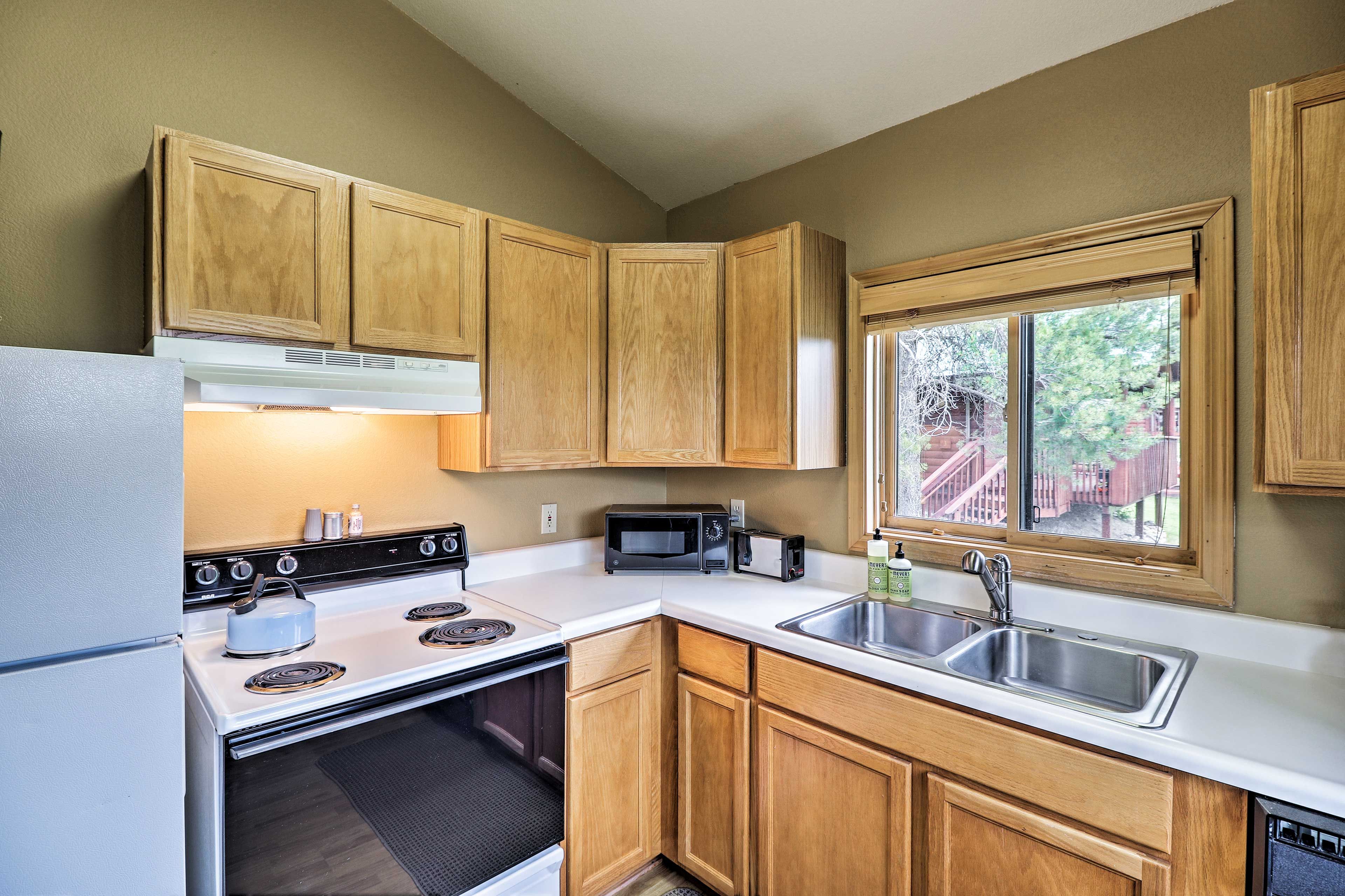 The kitchen is stocked with dishware and flatware.