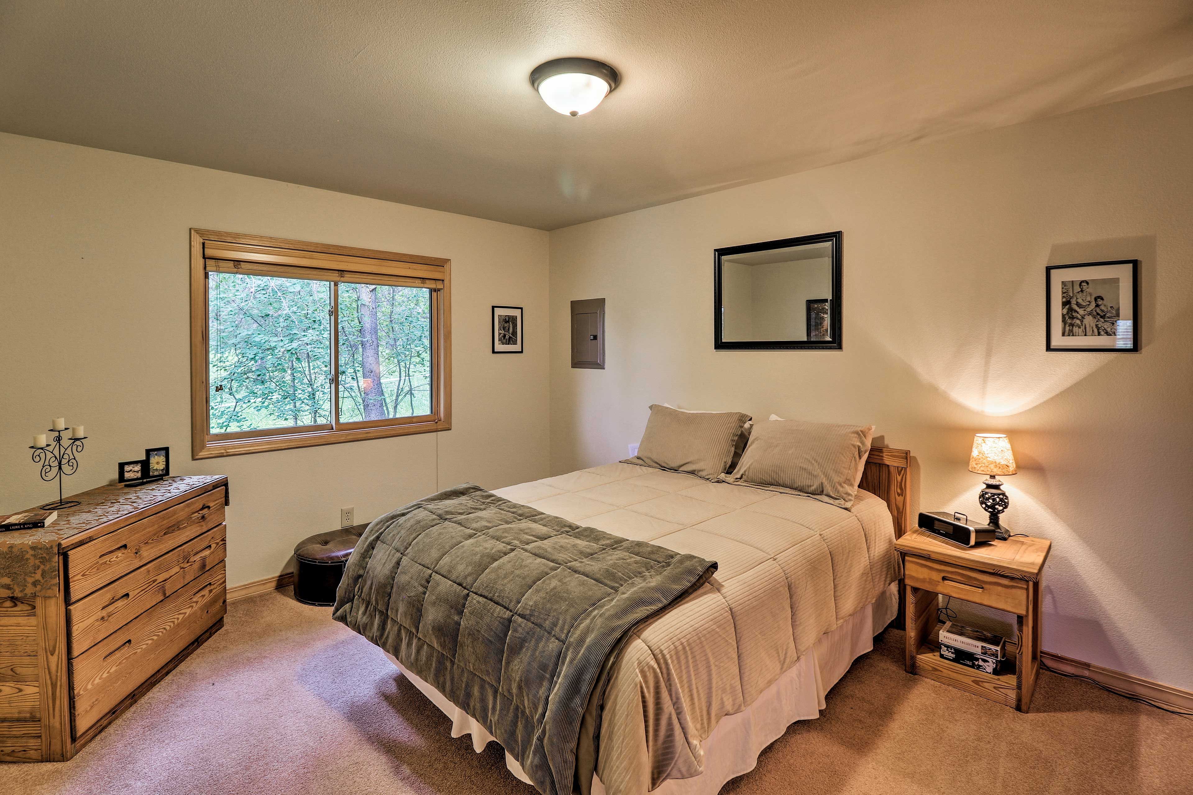 The bedroom features a queen bed.