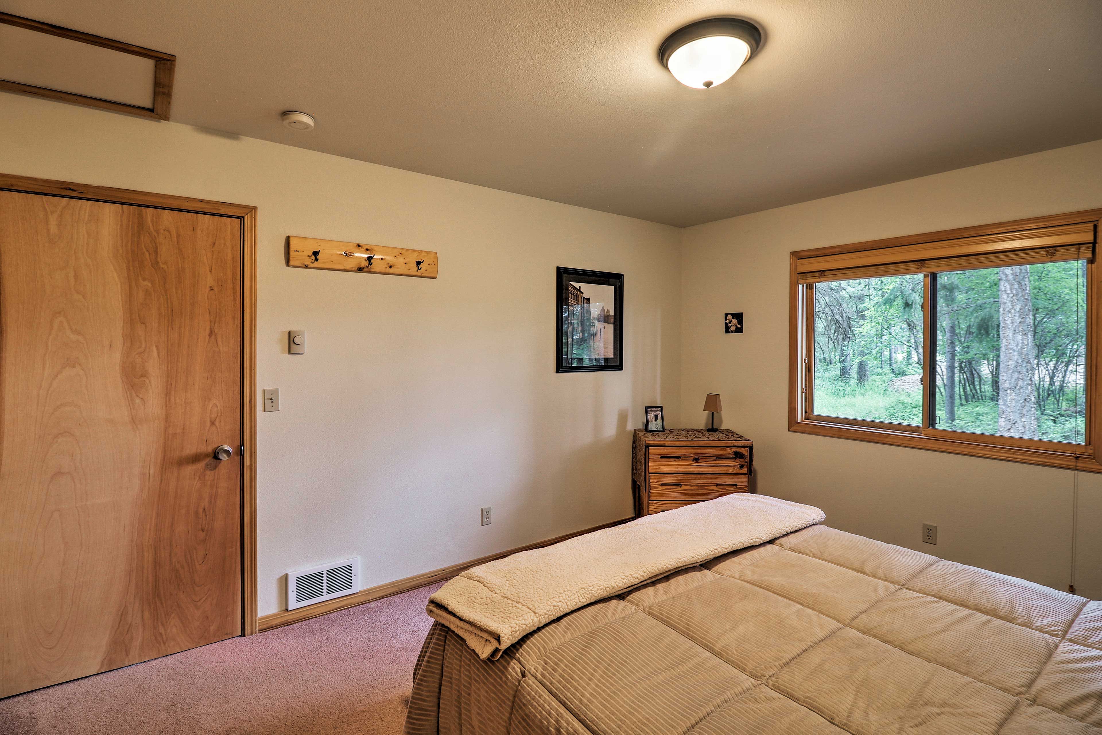 Store your clothes in the dresser and small chest of drawers.