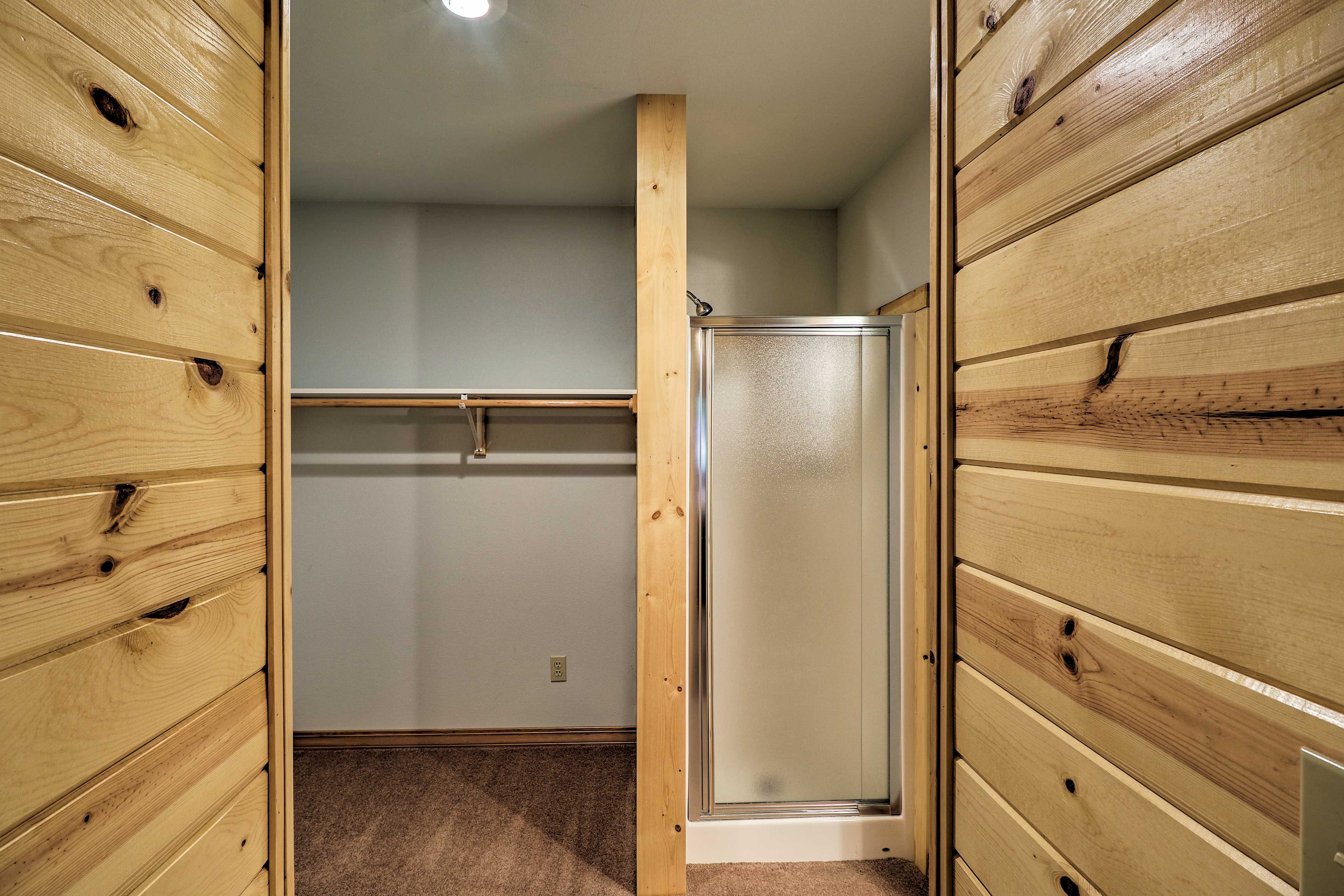 The closet space has a walk-in shower.