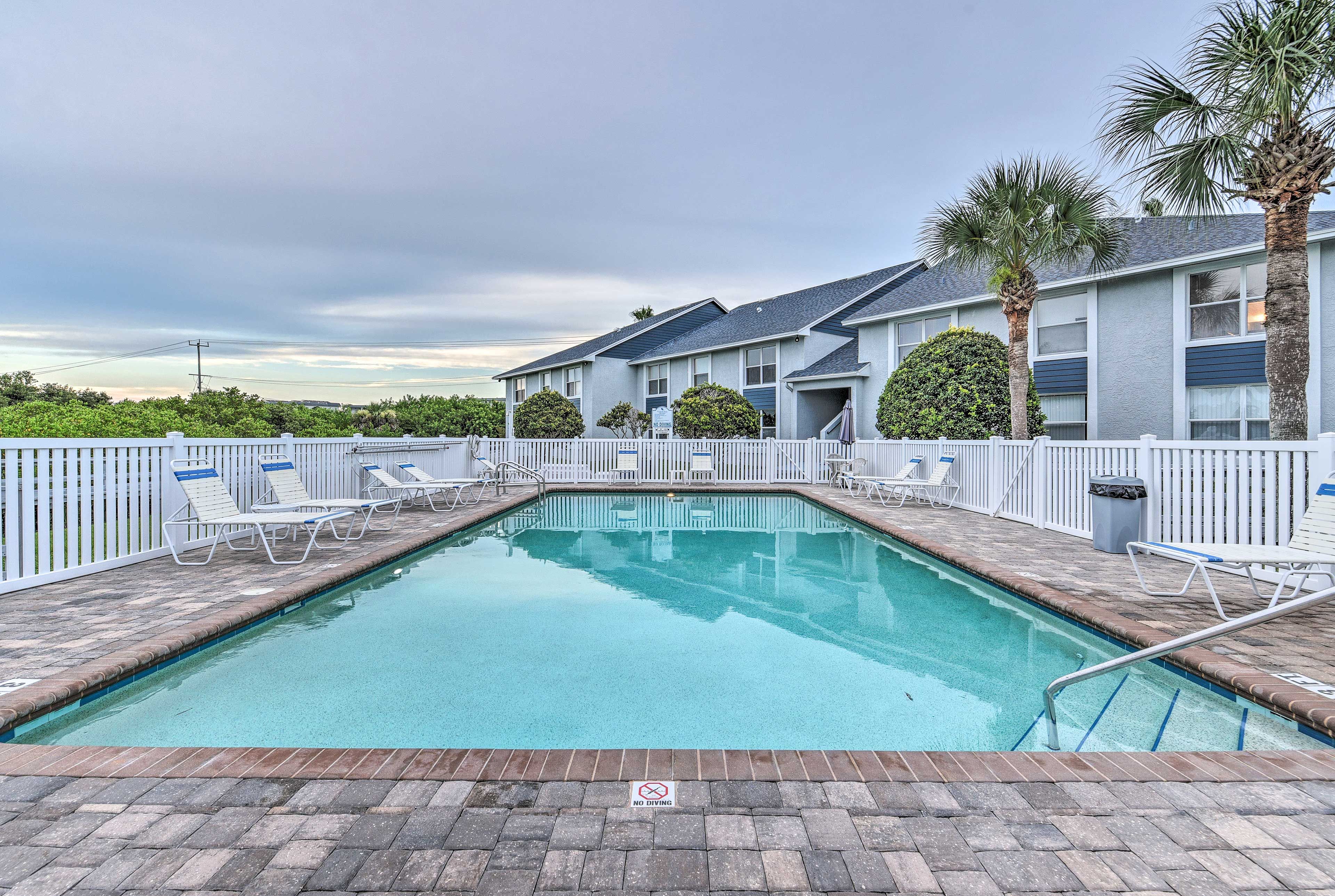 This condo includes community amenities like this pool.