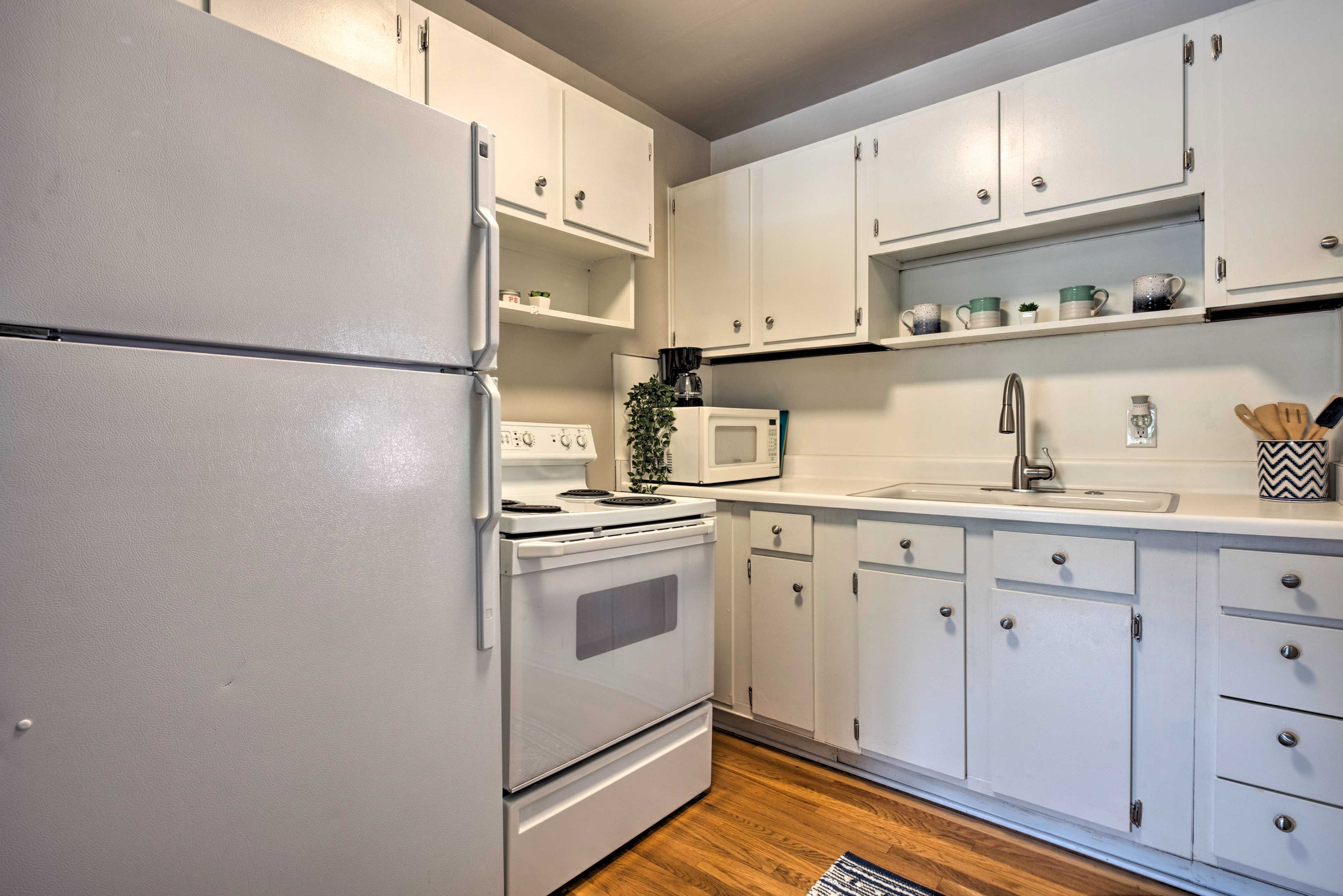 The kitchen features a full-sized fridge, oven/cook top and microwave.