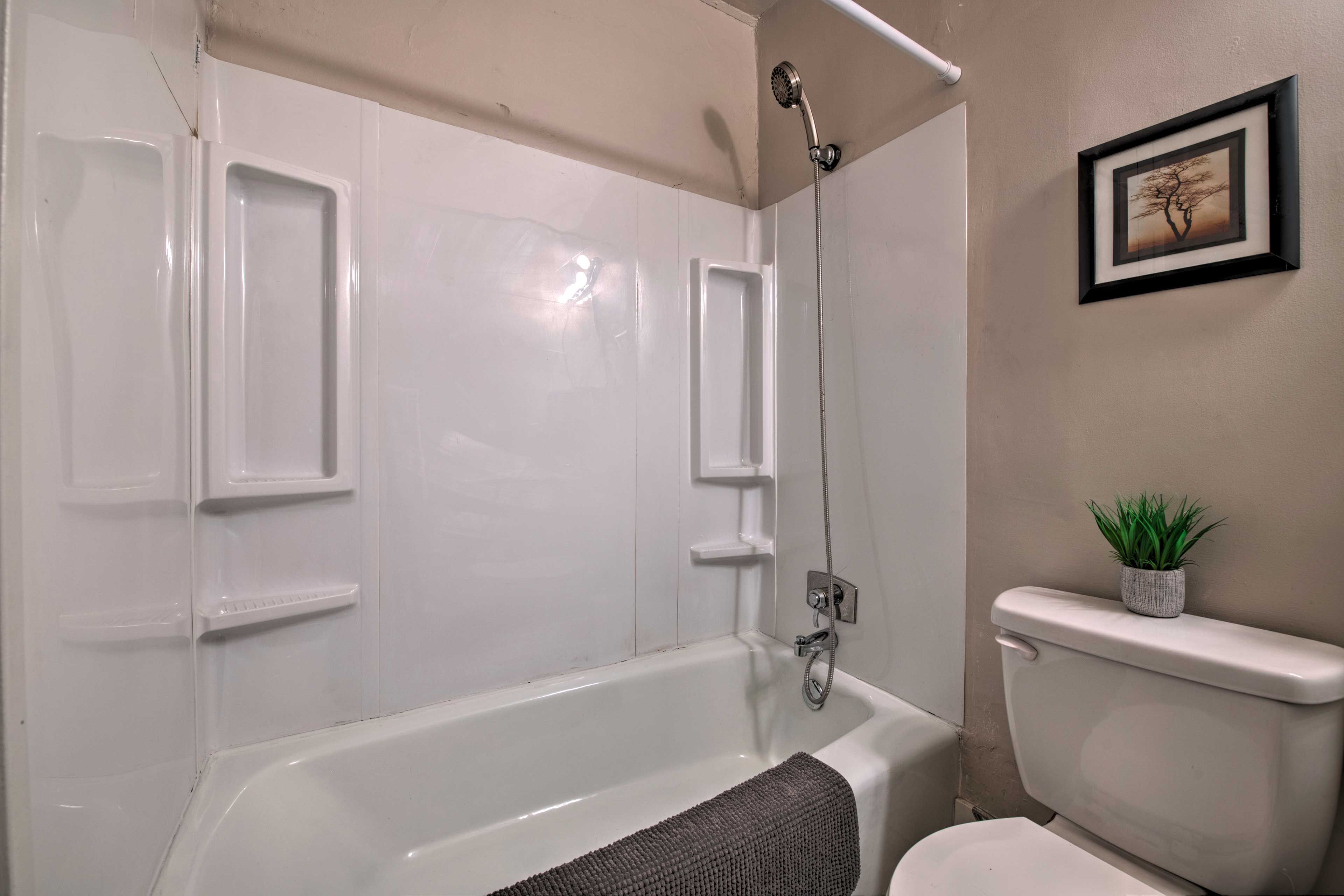 The full bath contains a mirrored vanity and tub/shower combo.