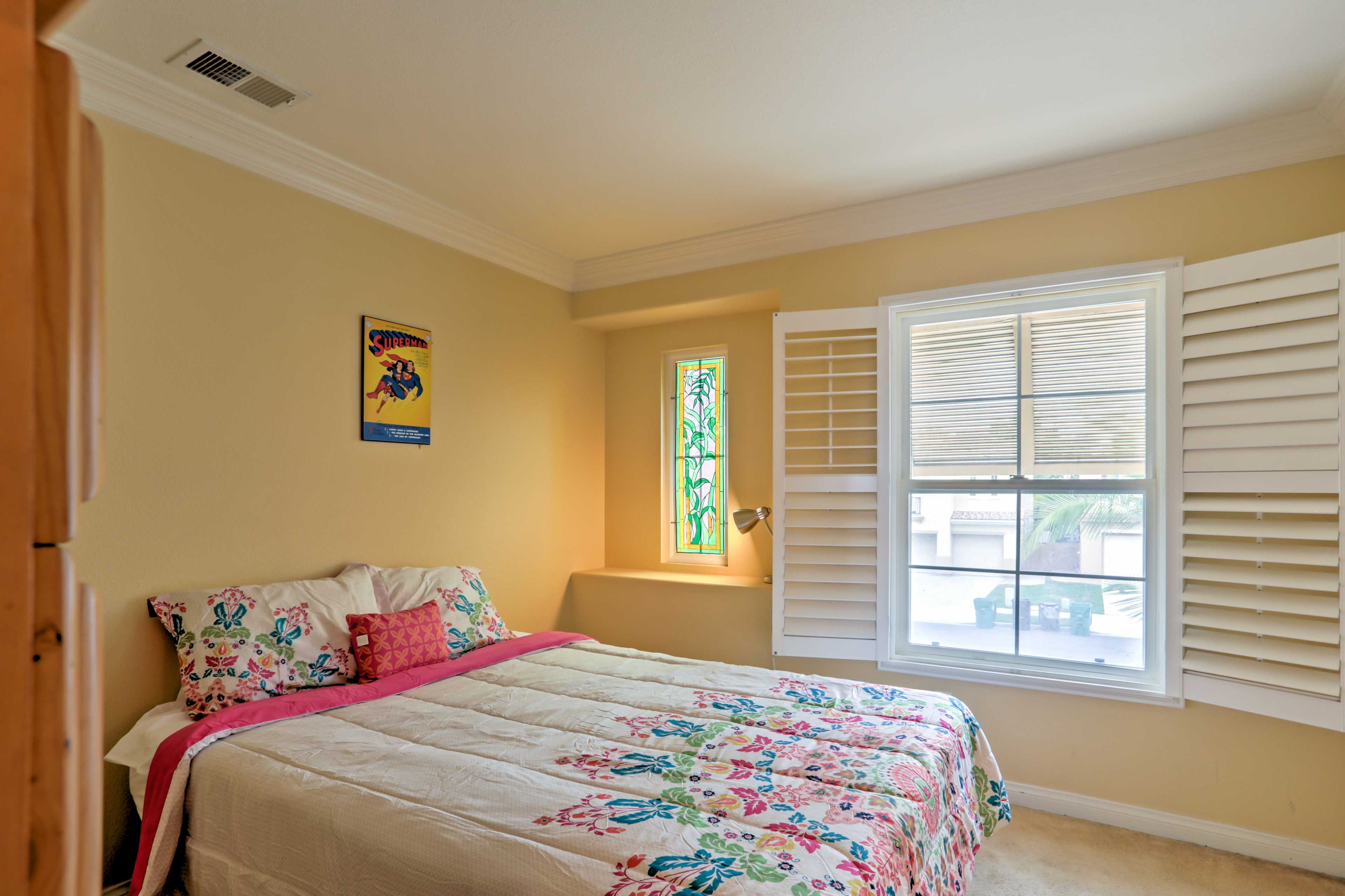 The Superman Room is highlighted by a plush queen bed.
