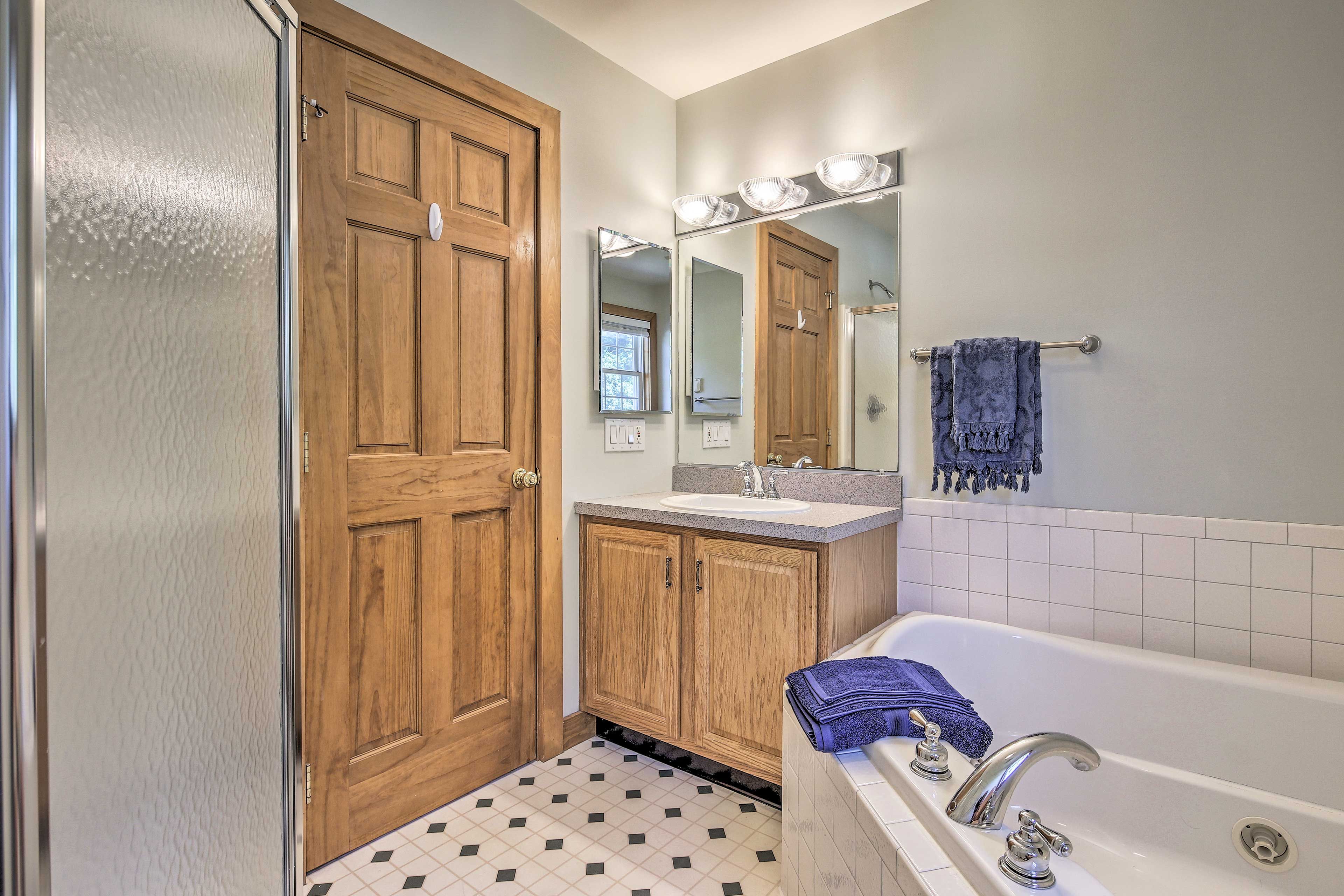The en-suite boasts a jetted tub and glass-enclosed shower.