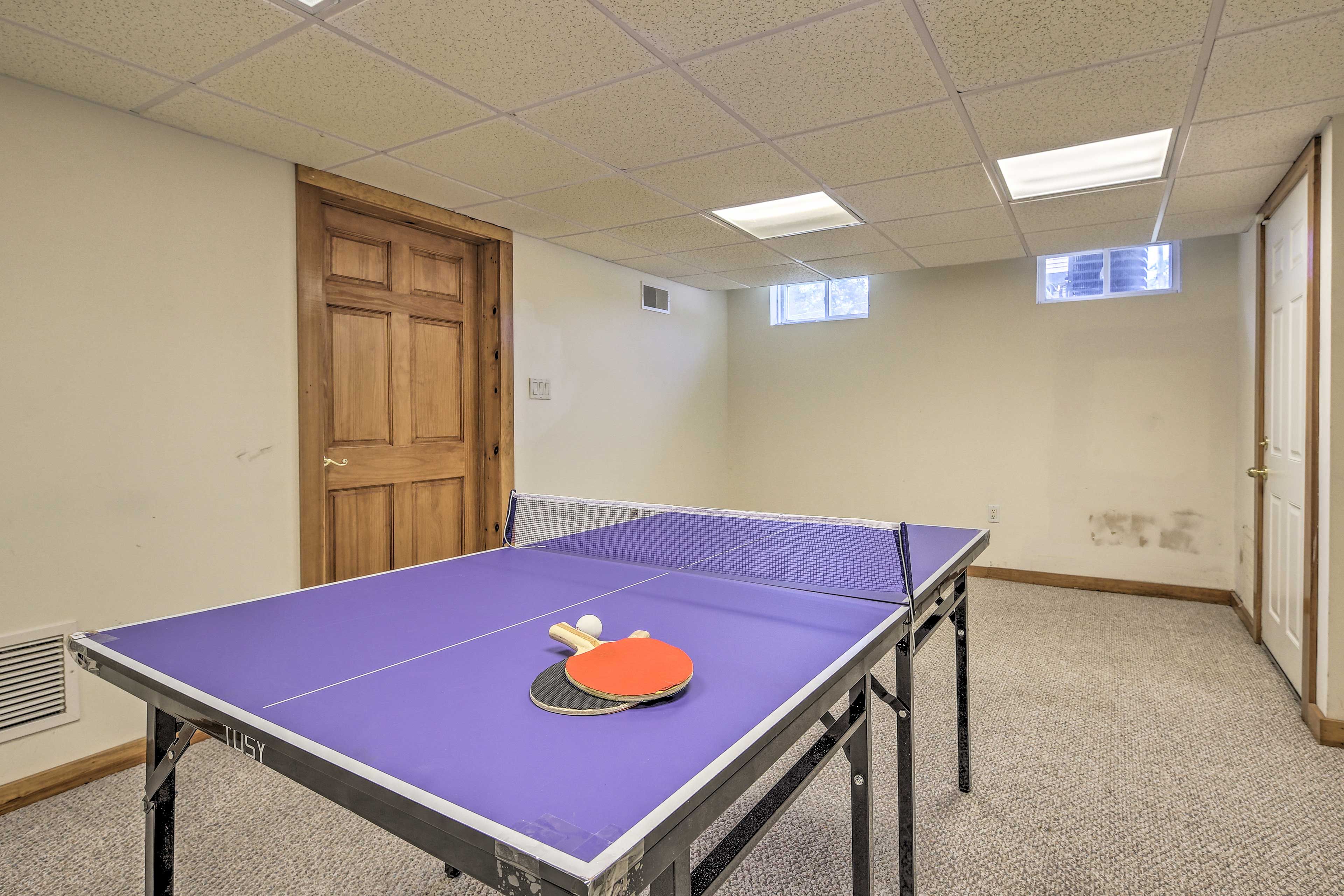 Downstairs, the finished basement boasts a ping pong table.