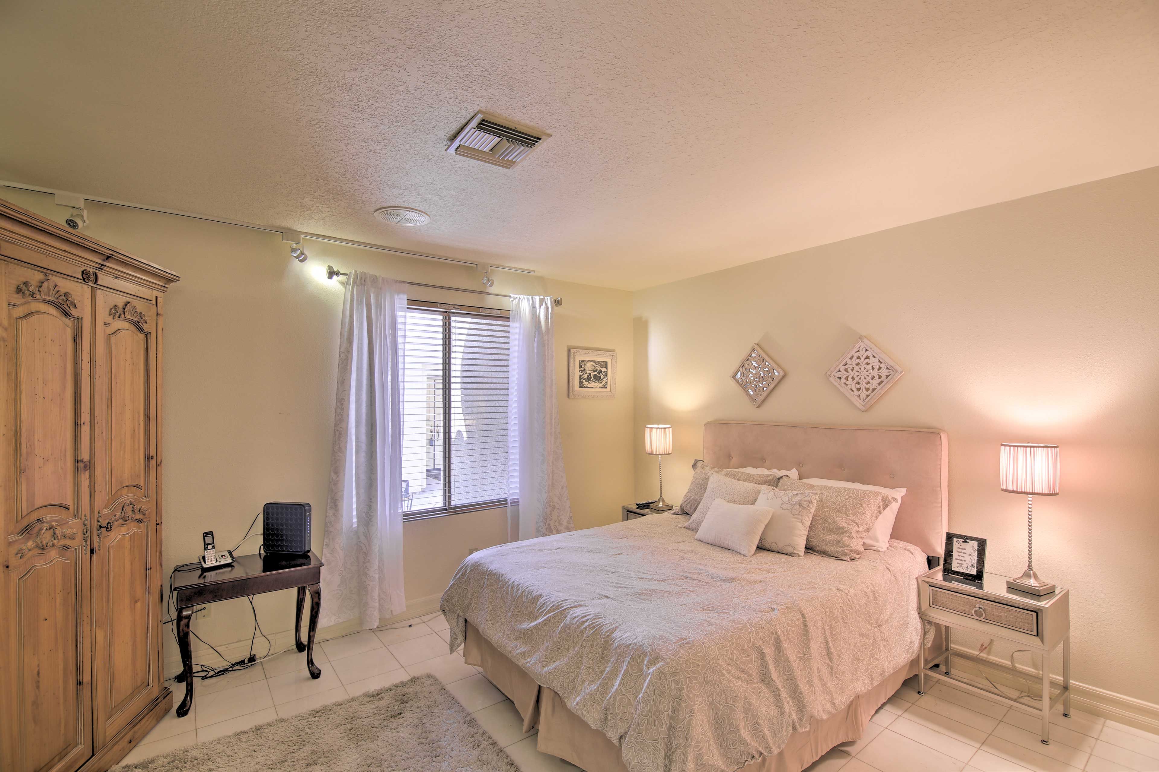 This bedroom is complete with a queen bed.