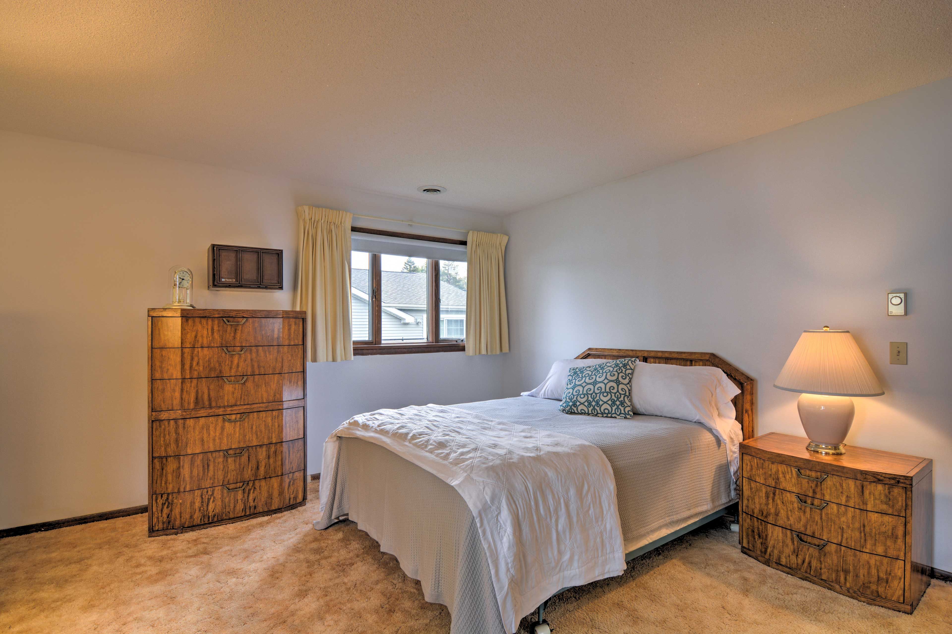 Bedroom 1 is complete with a queen-sized bed.