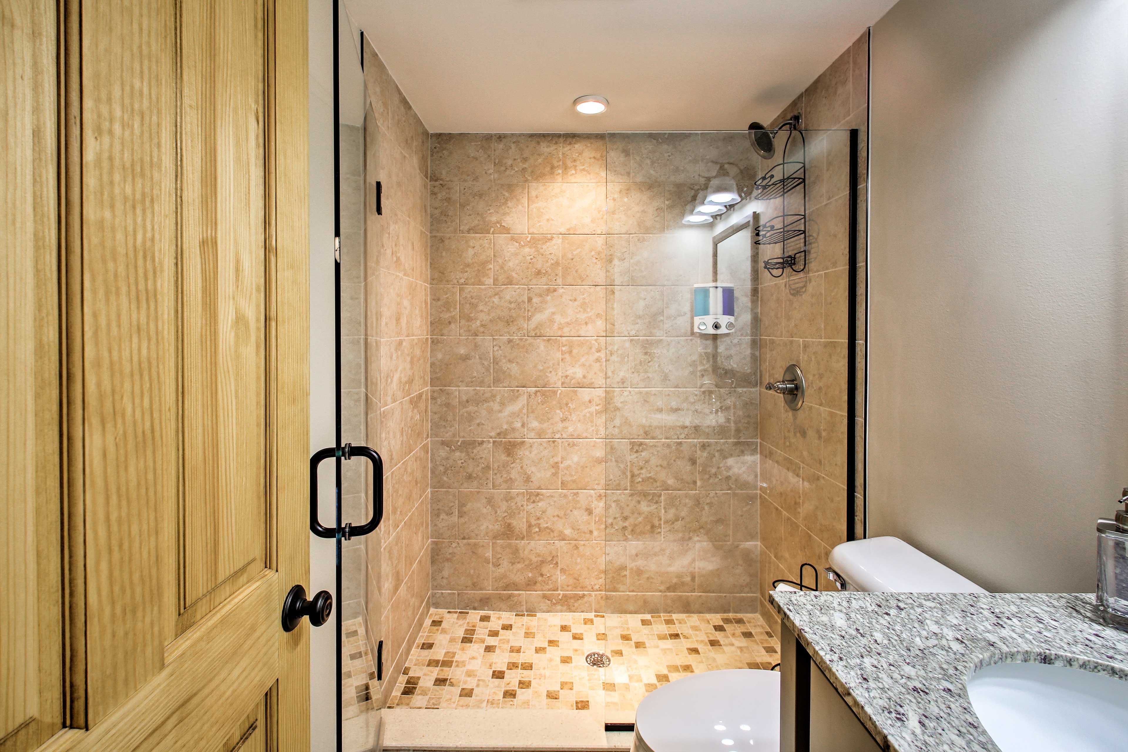 The first bathroom hosts a walk-in shower.