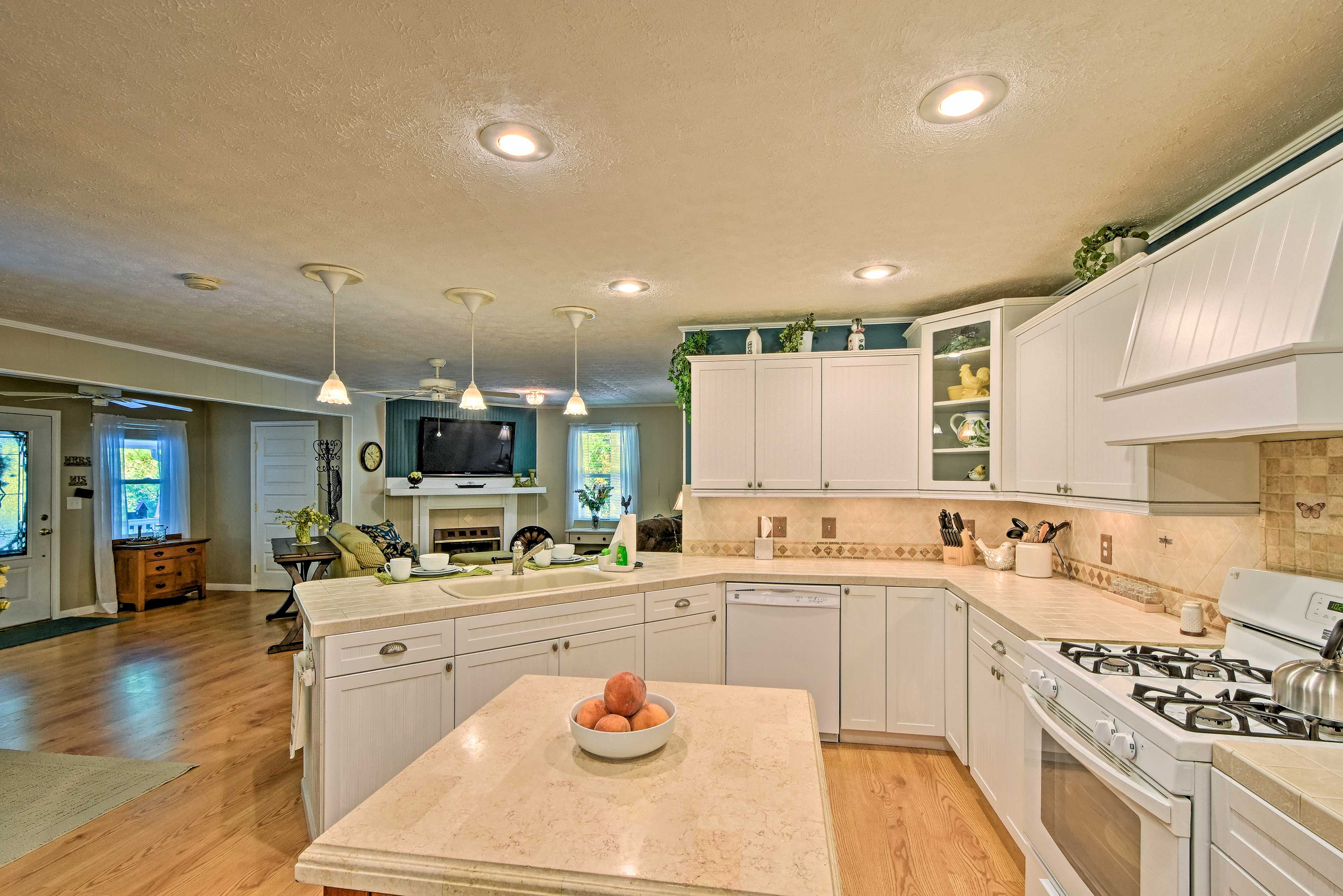 The spacious kitchen is complete with a center island & cooking basics.