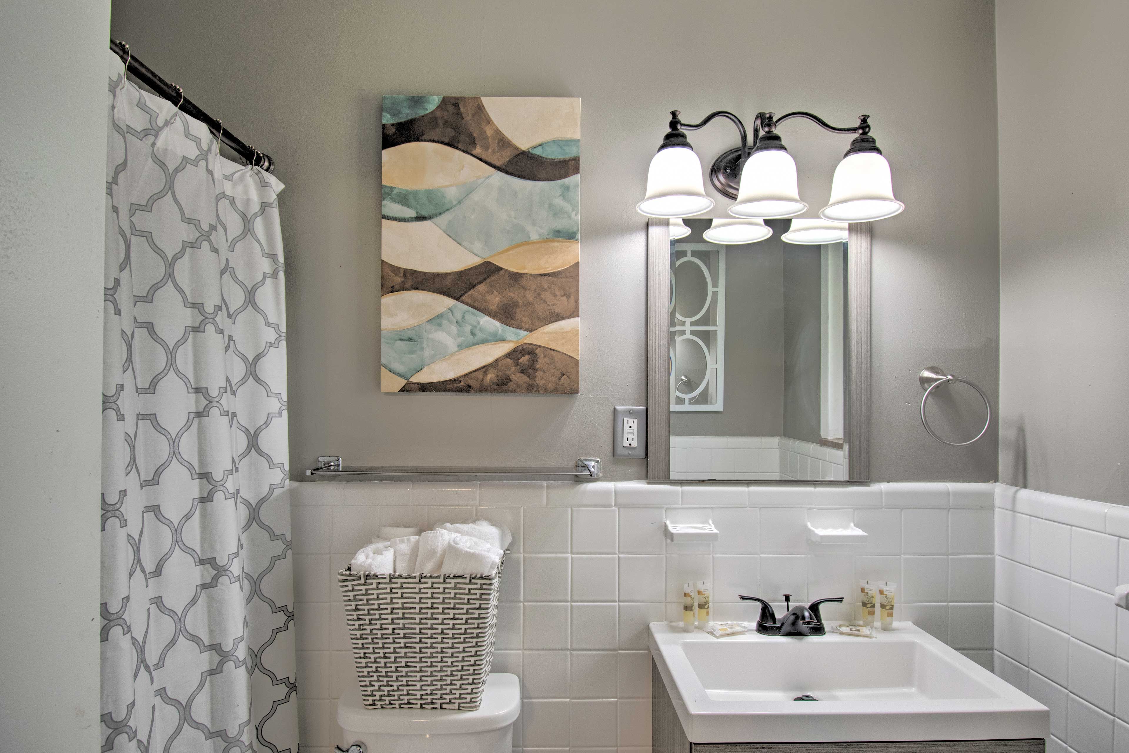 The full bathroom features a shower/tub combo and neutral colors.