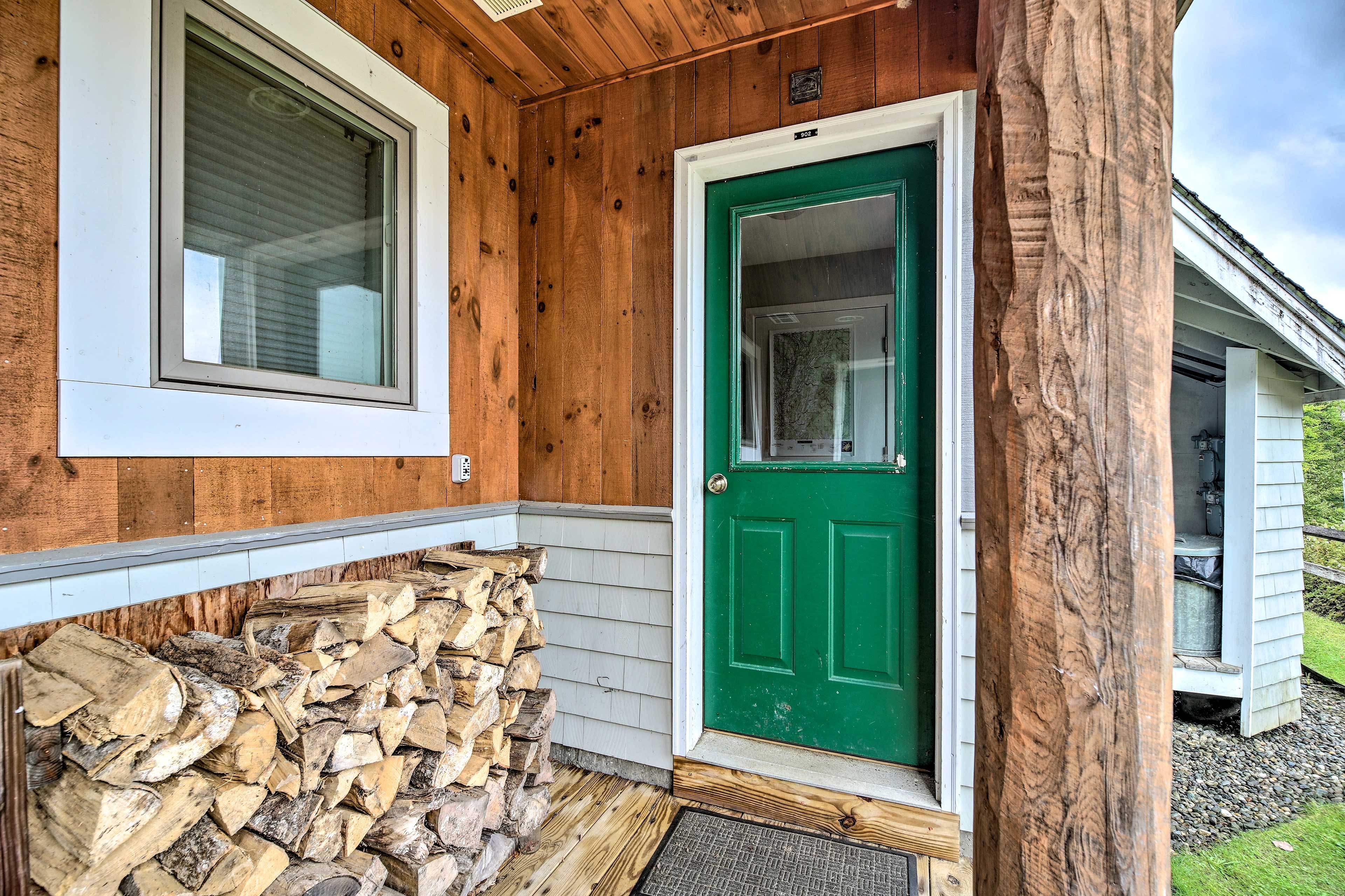 Extra wood is located on the porch.