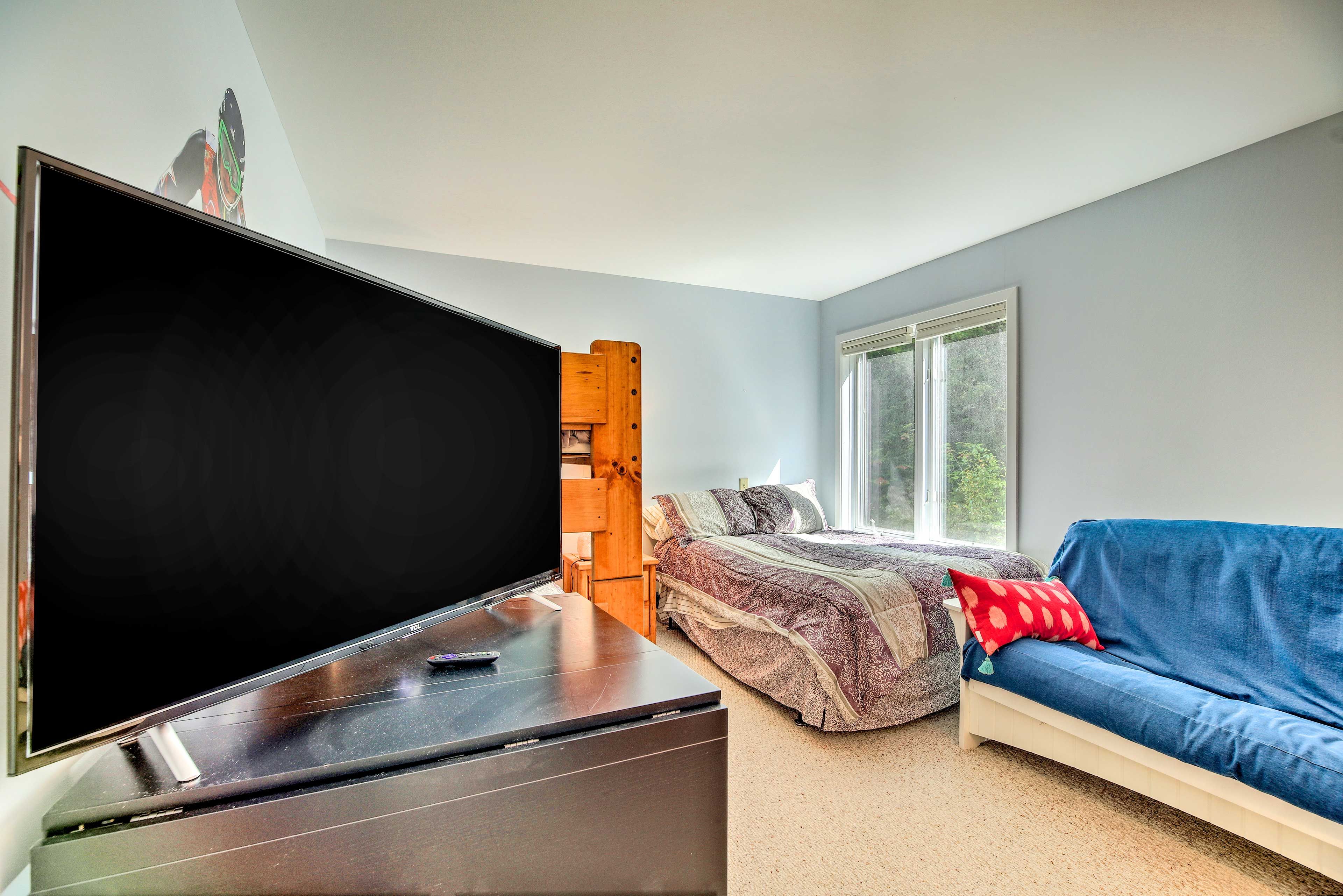 The second bedroom boasts a large flat-screen TV.