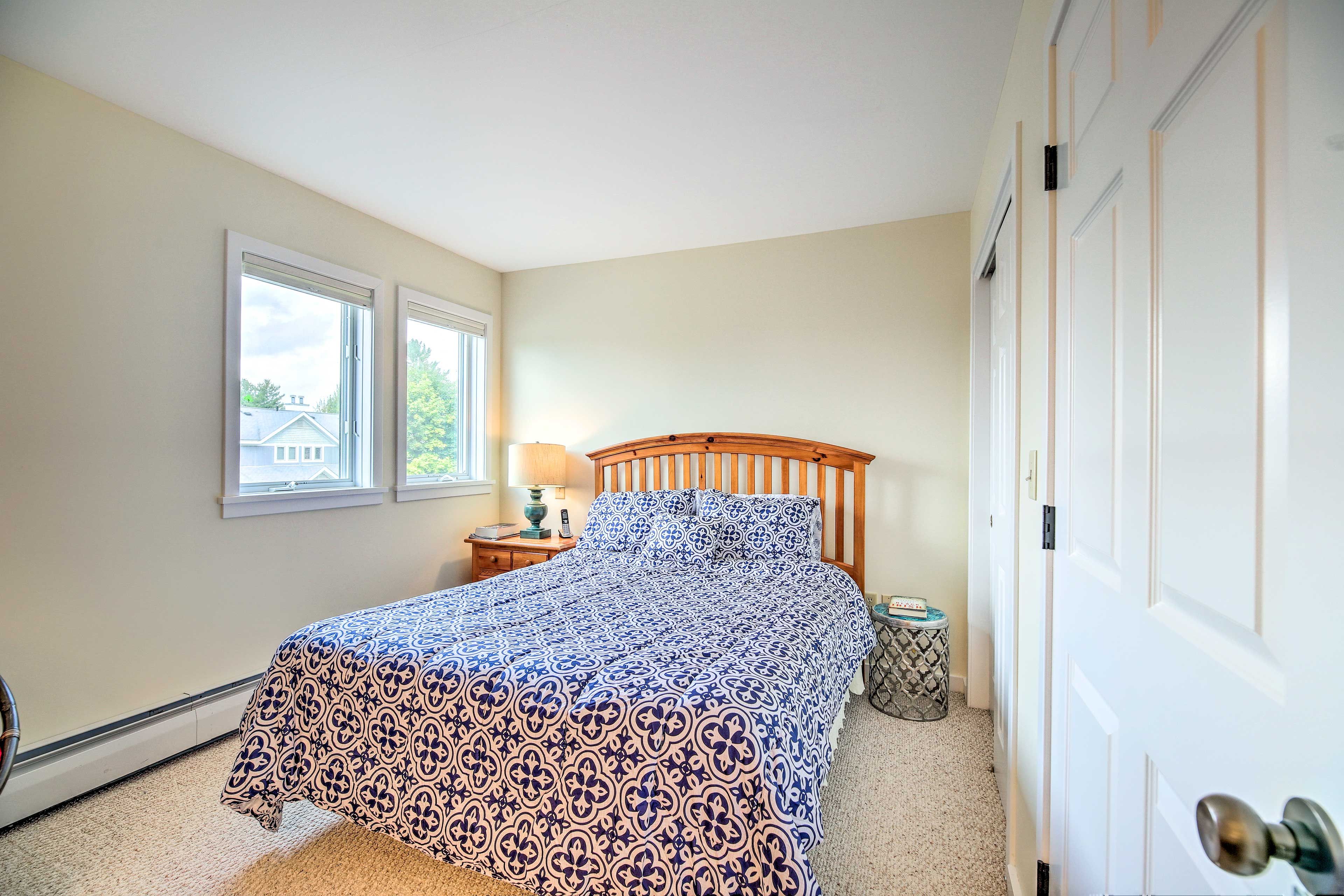 The first bedroom features a queen bed.