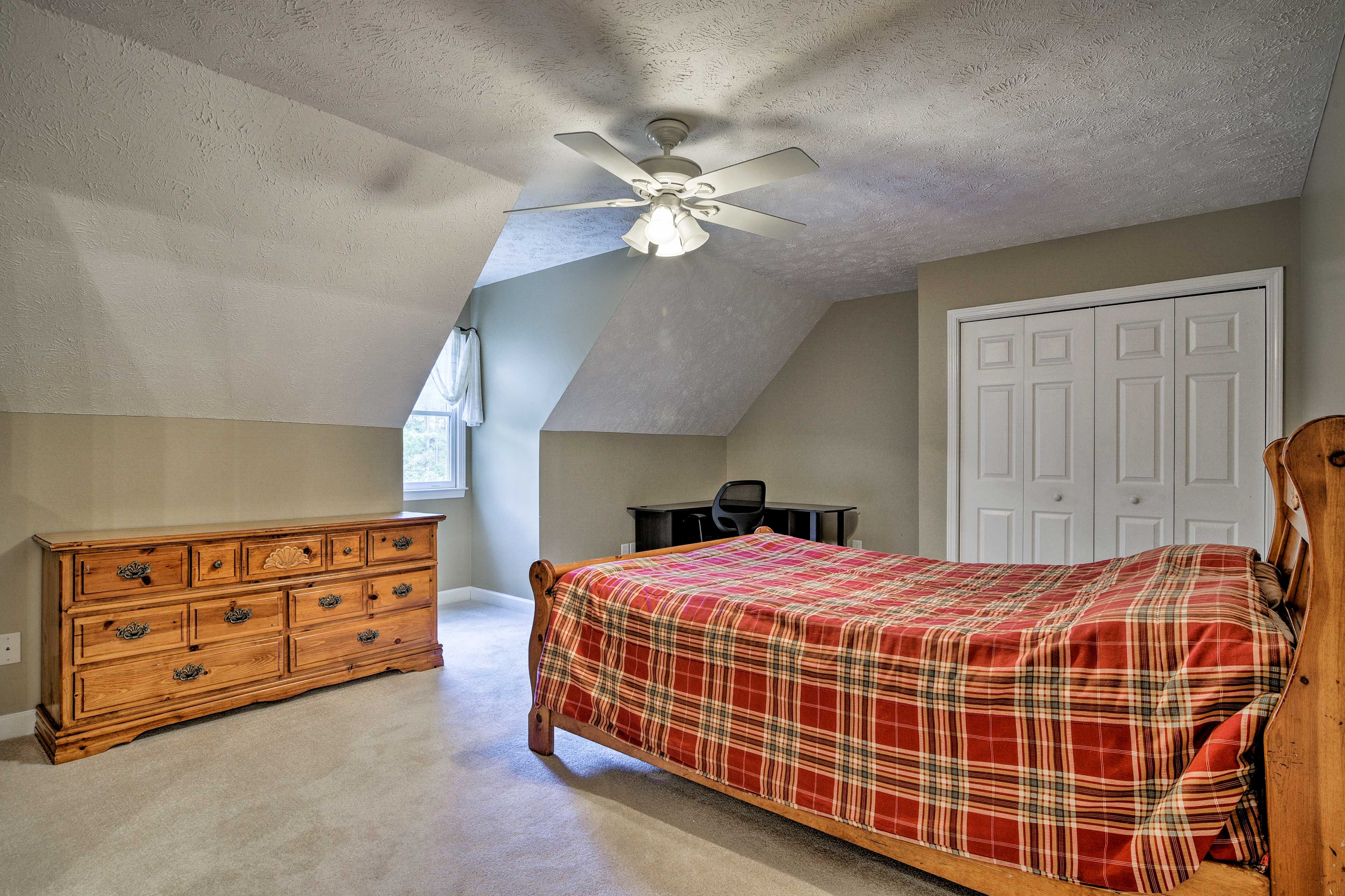 The bedroom features a queen-sized bed.