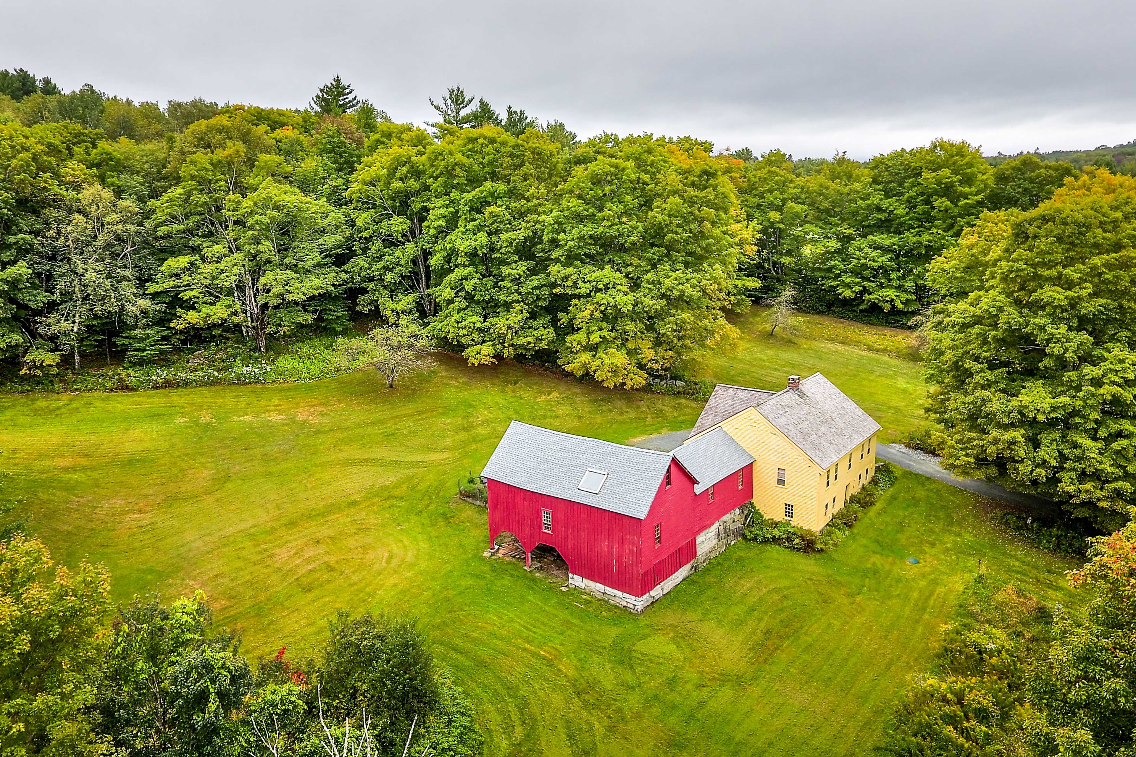 This farmhouse sits on 20 private acres nestled beside a preserve.