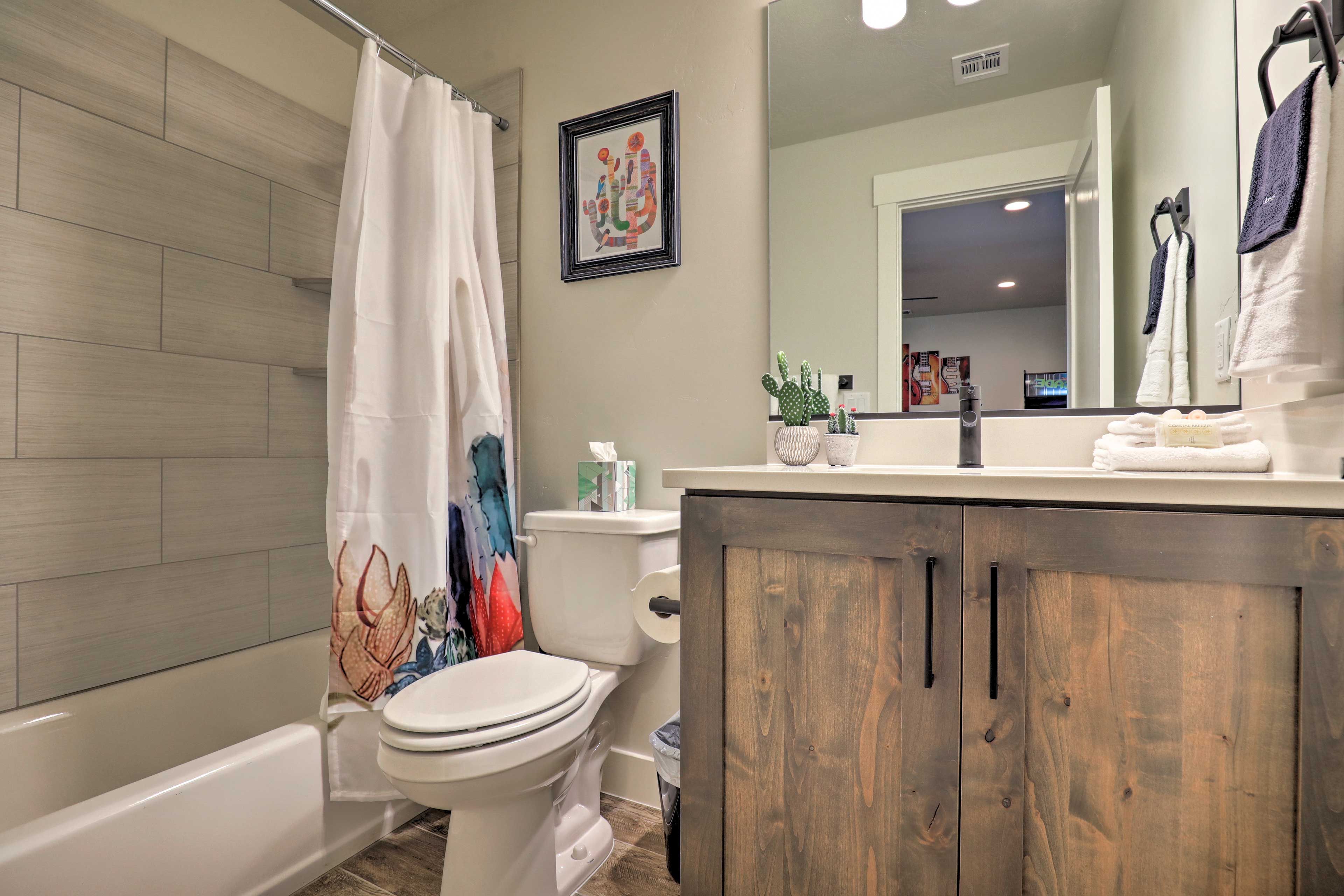 The second full bath features a tub/shower combo and mirrored vanity.