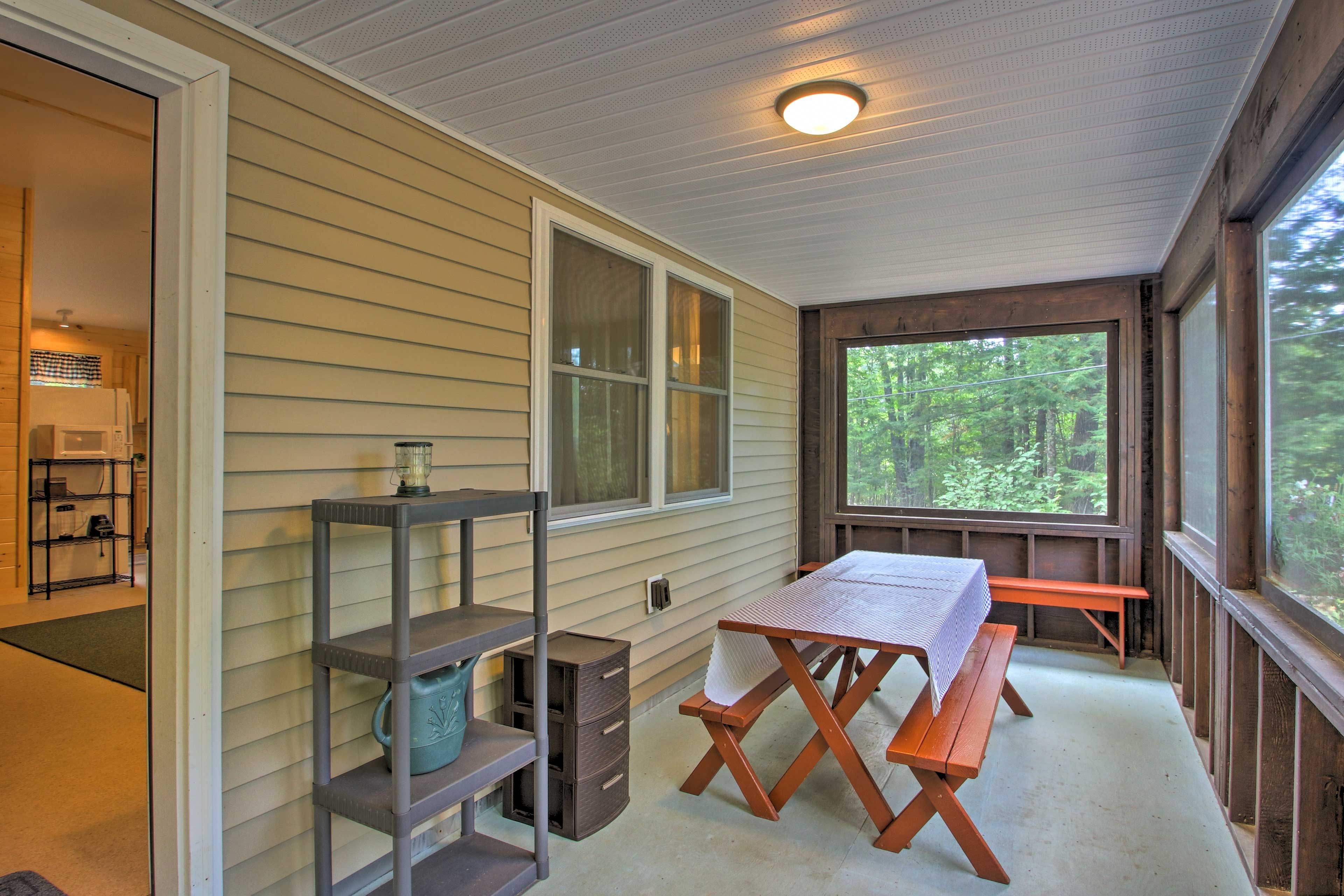 Play a game of cards on the screened-in porch's picnic table.