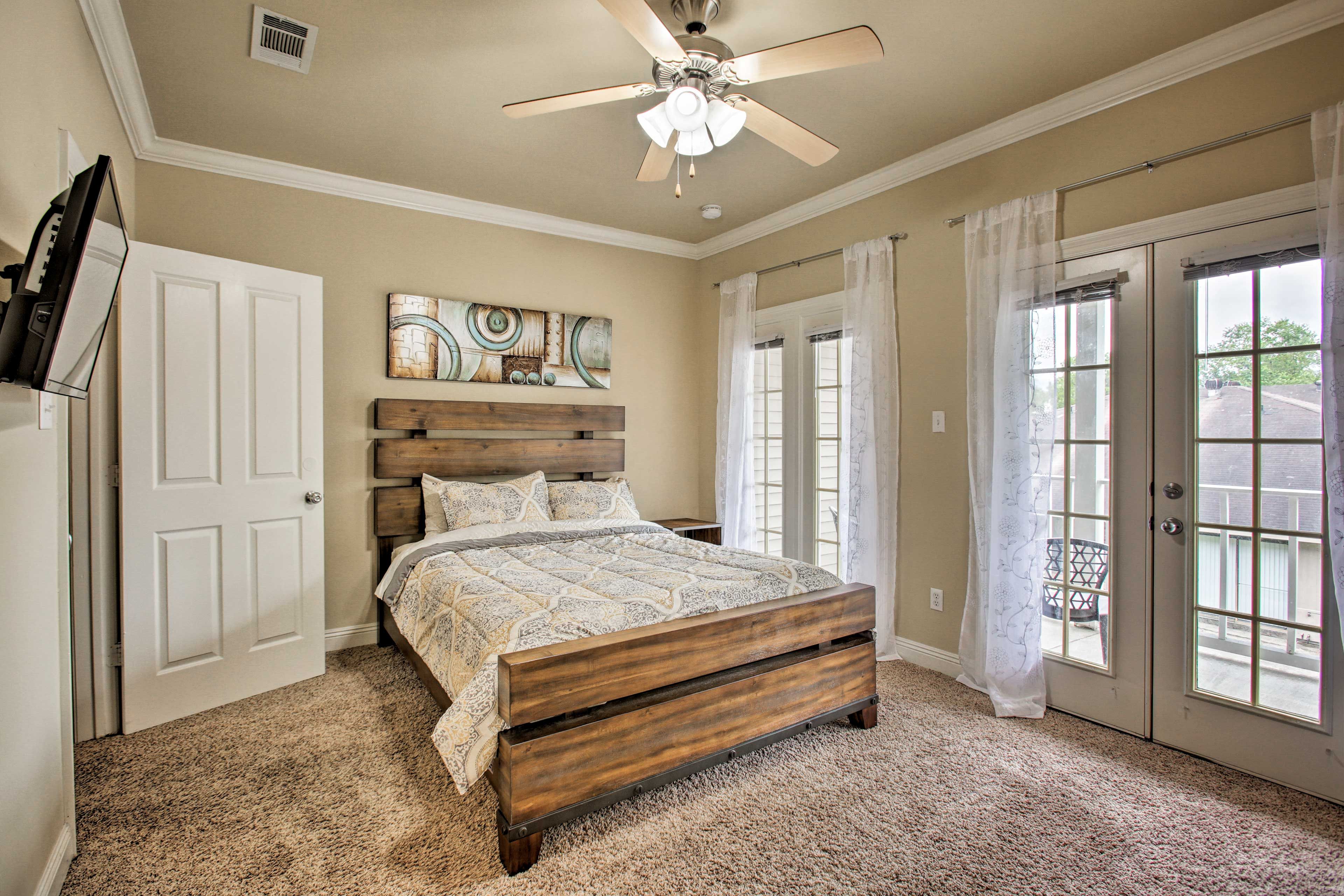 The room features a flat-screen TV and access to a balcony.