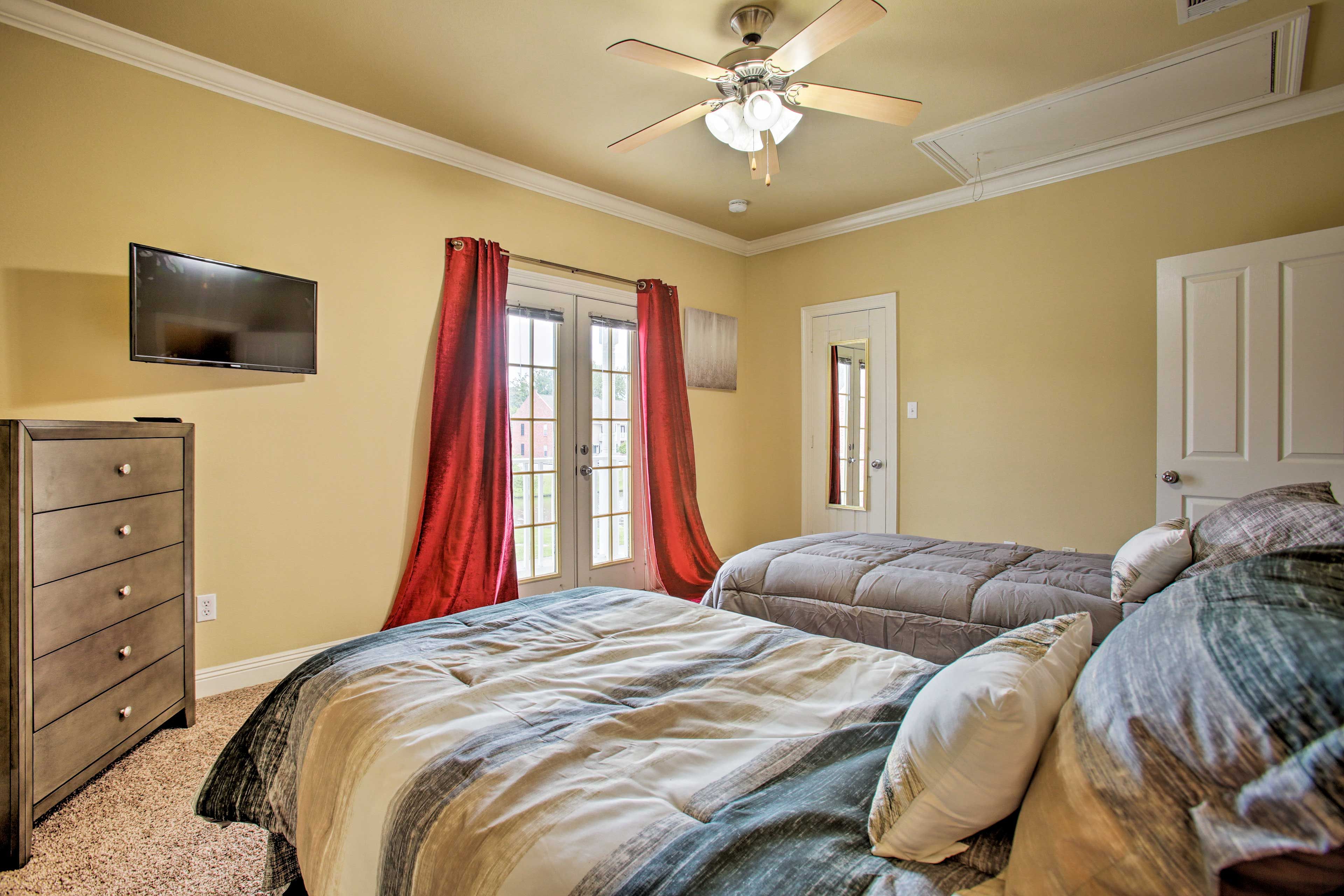 A flat-screen TV, en-suite bathroom & access to the balcony complete the space.