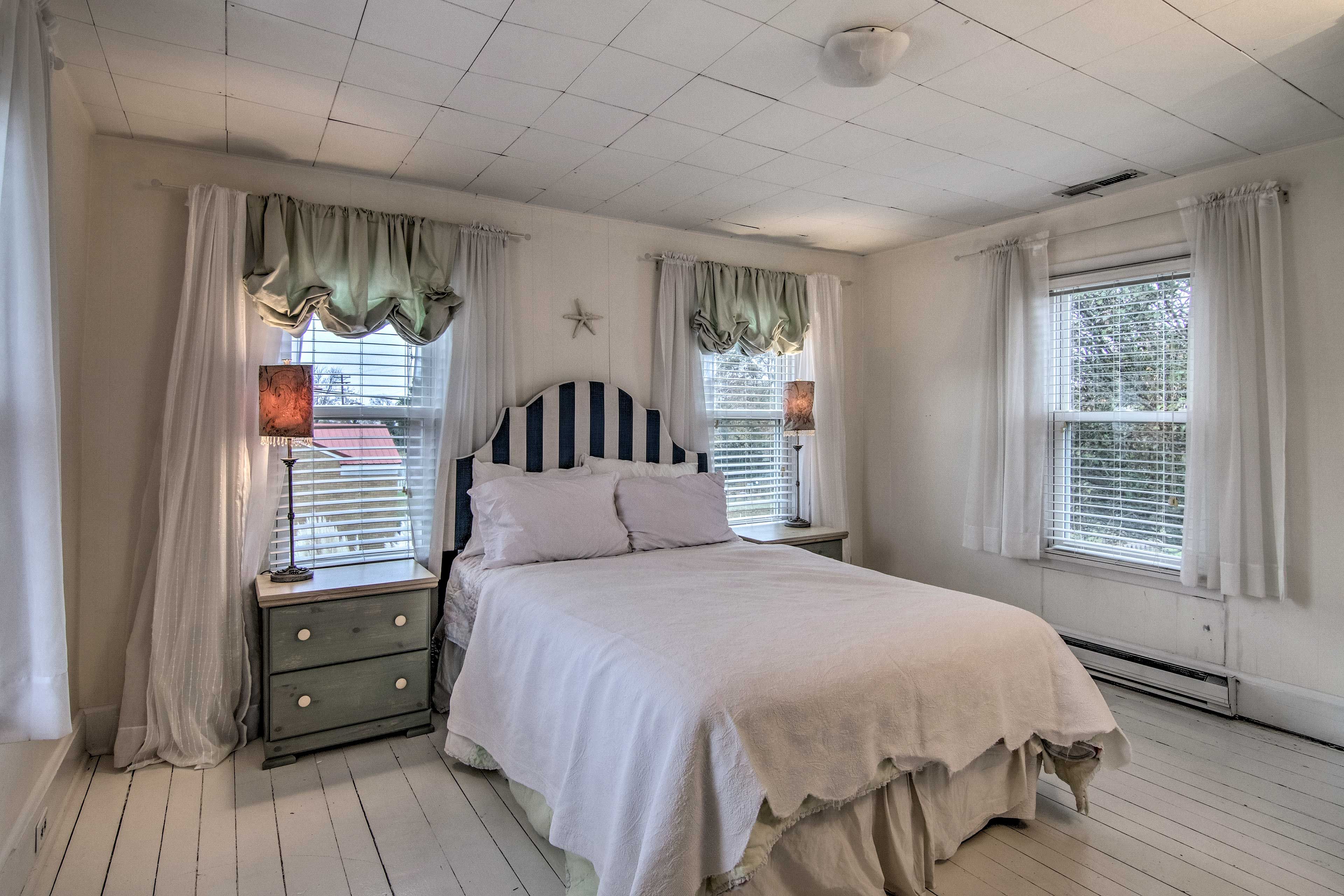 Bedroom 2 features a full bed and eclectic decor.
