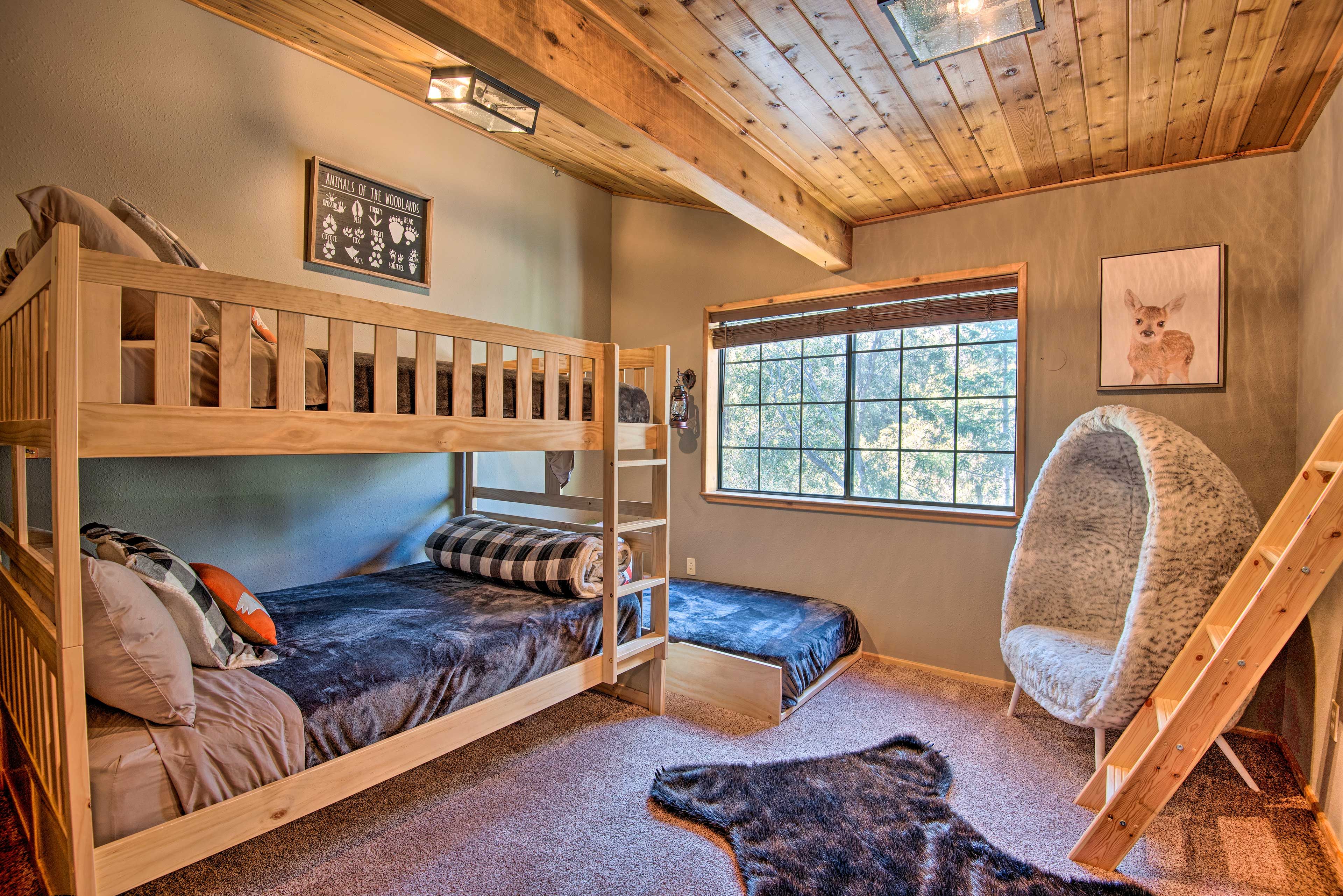 The second bedroom features 2 full bunk beds and a twin bed.