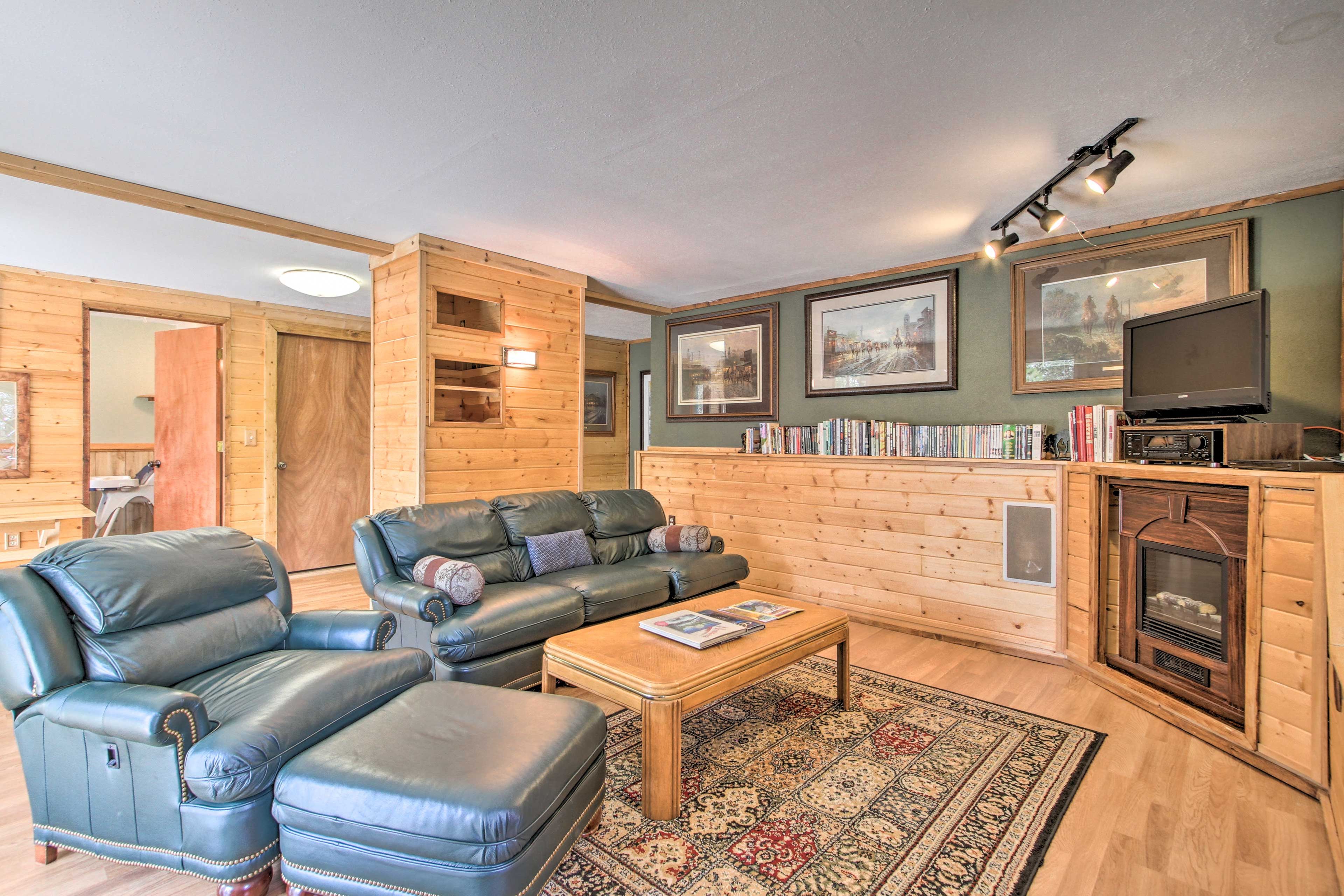 This cozy room features an electric fireplace, movies and a TV.