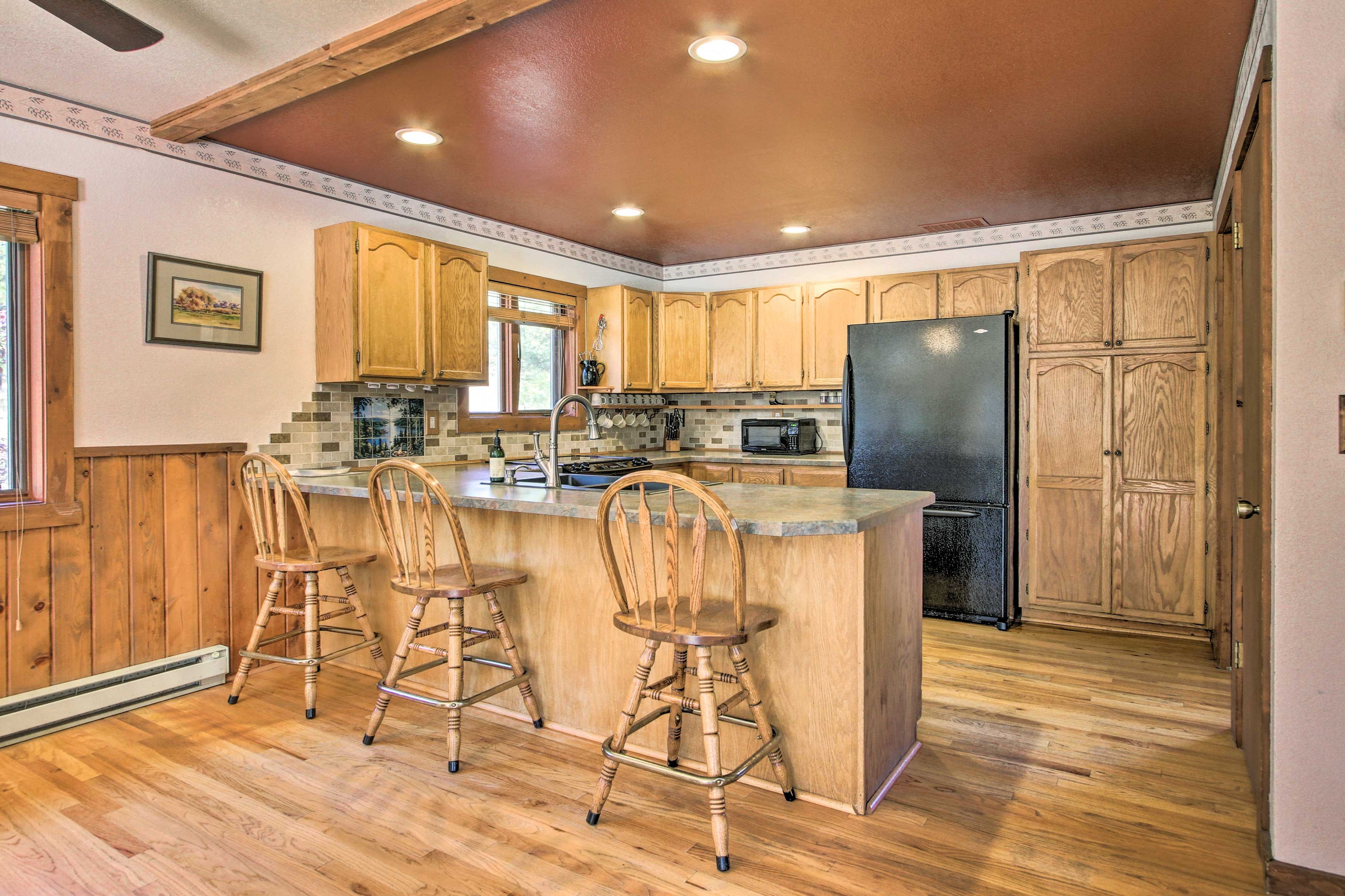 Find seating for 3 more guests at the breakfast bar.