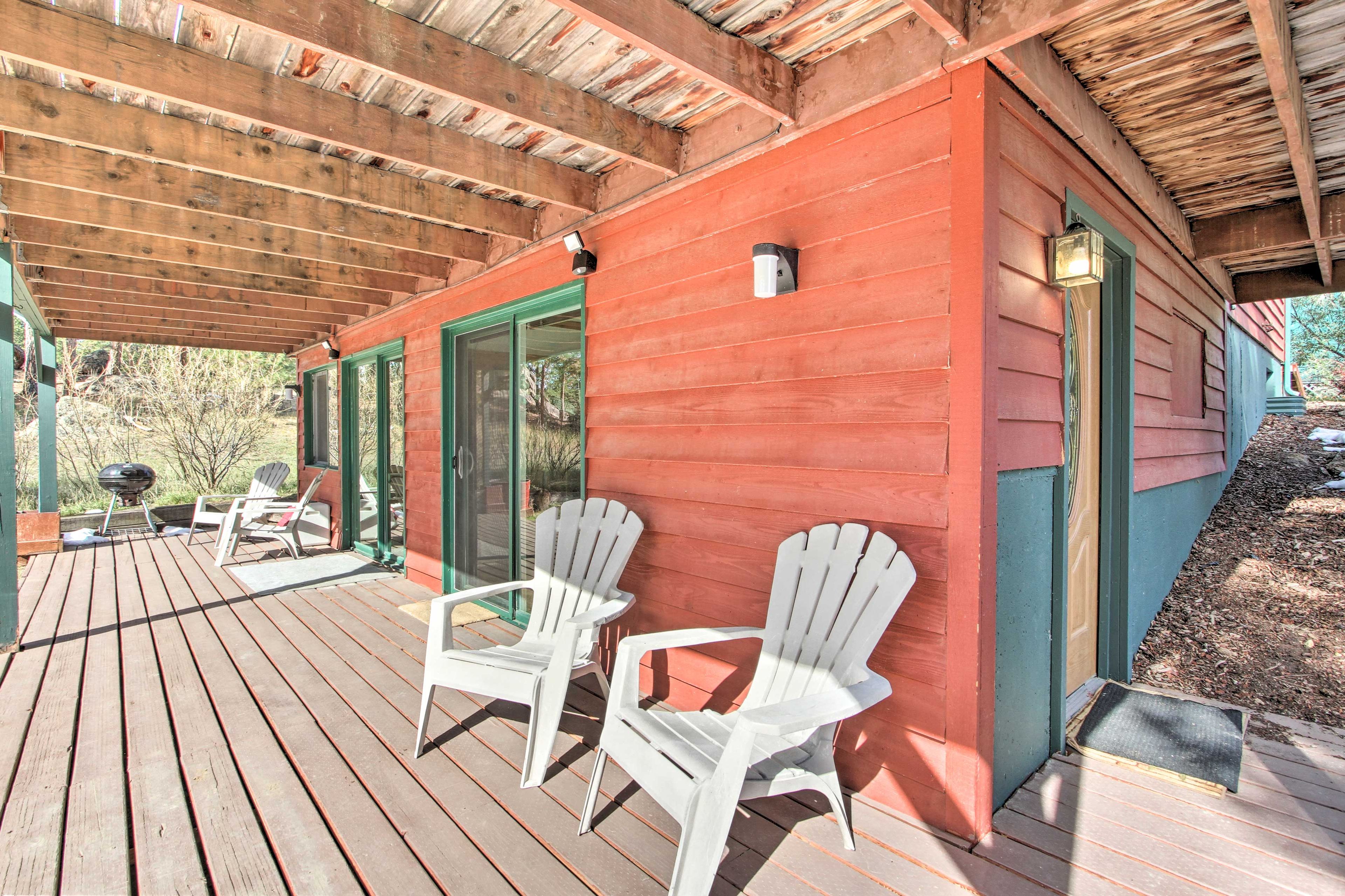Take a seat outside on the covered deck, which boasts a charcoal grill.