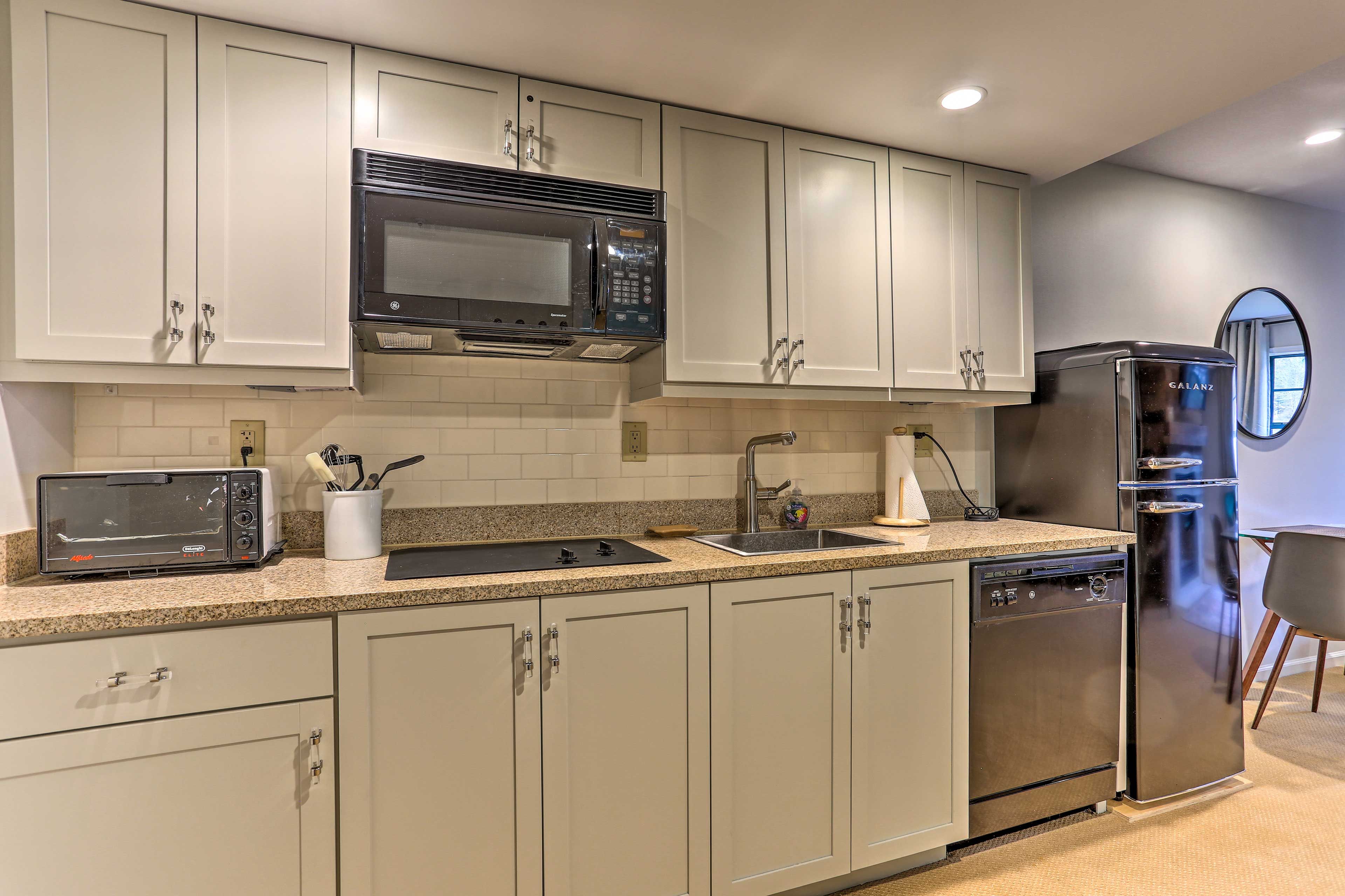 A fully equipped kitchen is ready for cooking.