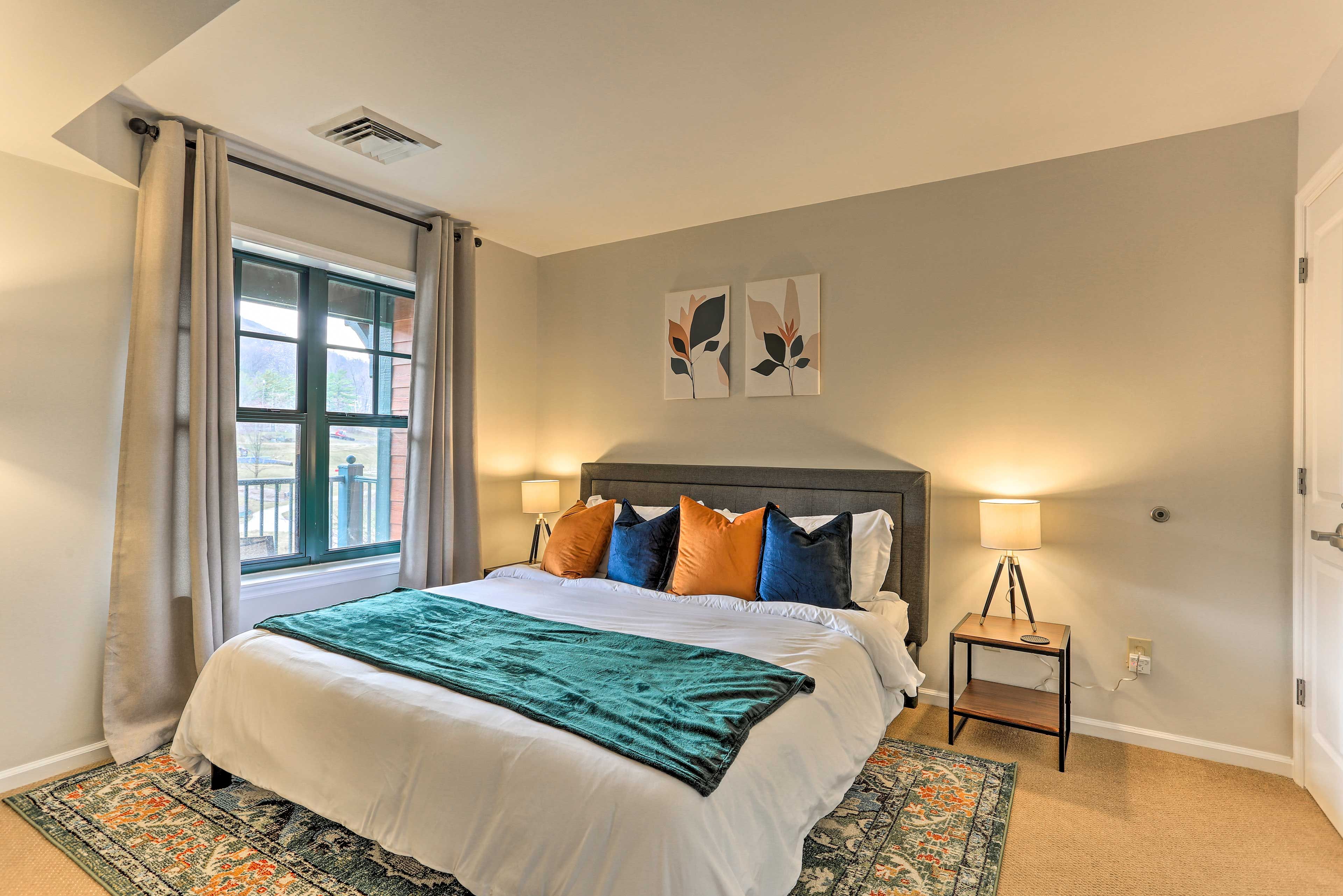 The master bedroom's king bed invites you to rest your head.